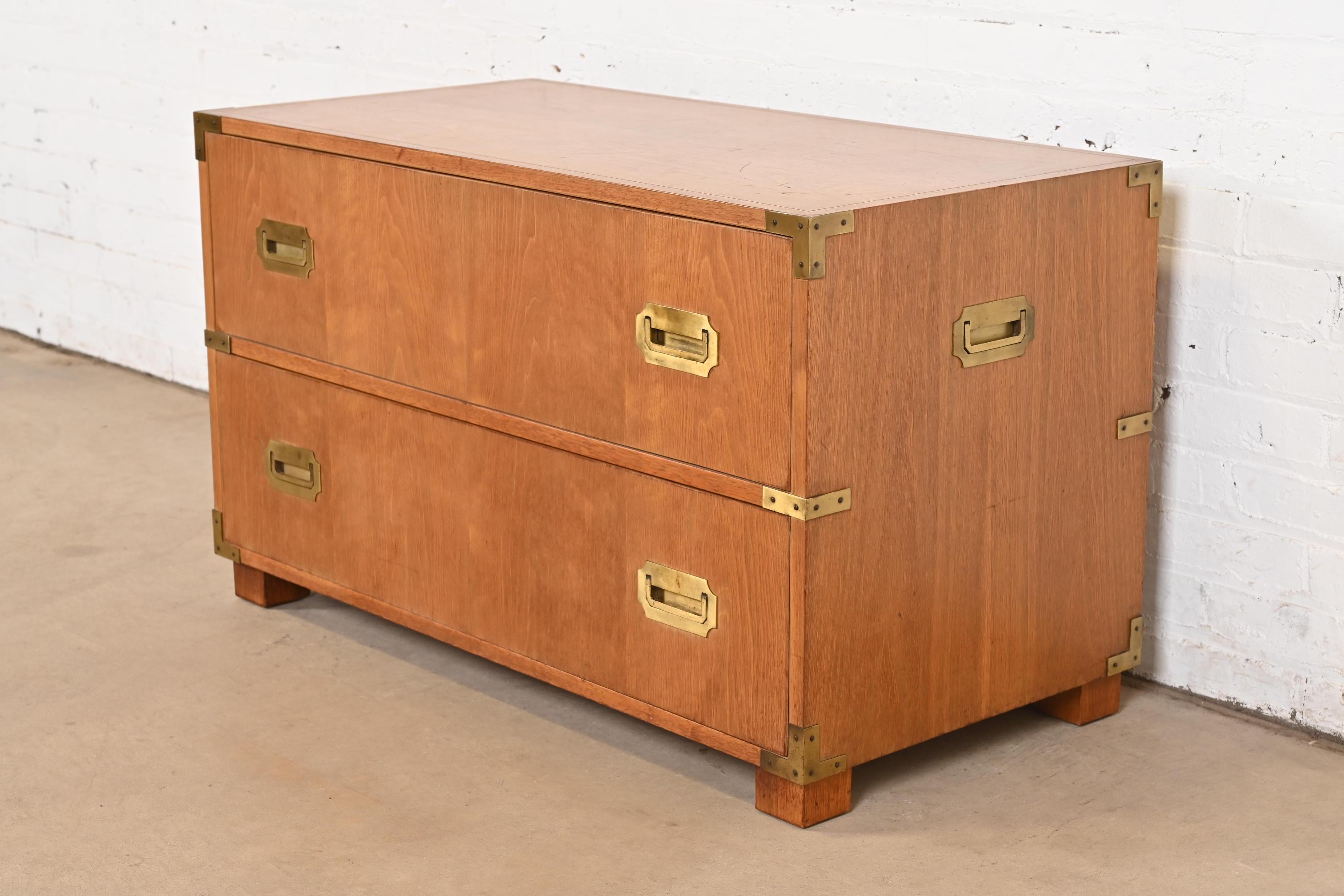 A stunning mid-century modern Hollywood Regency Campaign style two-drawer lowboy dresser, commode, or chest of drawers

By Michael Taylor for Baker Furniture, 