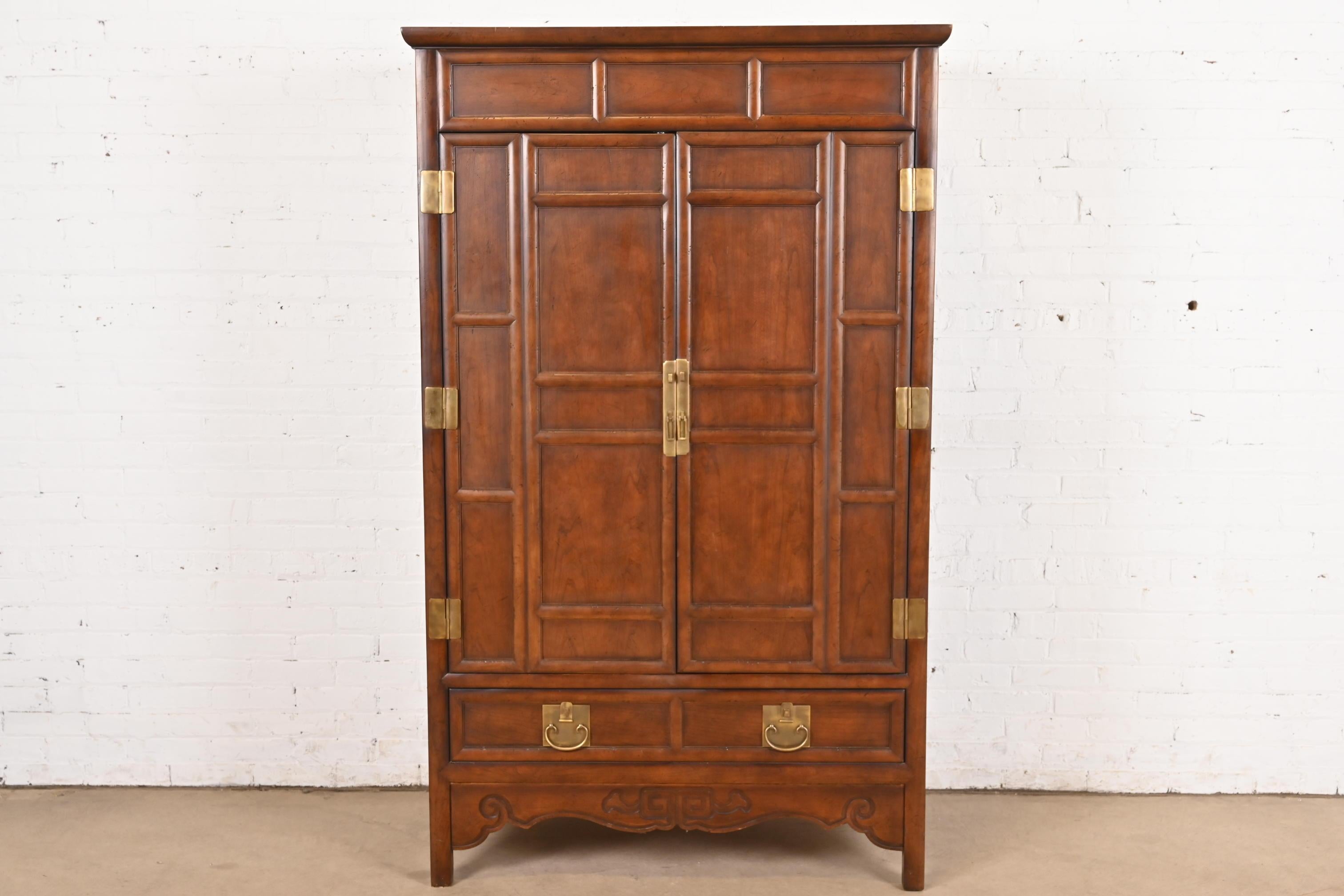 A stunning mid-century modern Hollywood Regency Chinoiserie media cabinet or armoire

By Michael Taylor for Baker Furniture

USA, Late 20th Century

Gorgeous carved walnut, with original Asian-inspired brass hardware.

Measures: 44