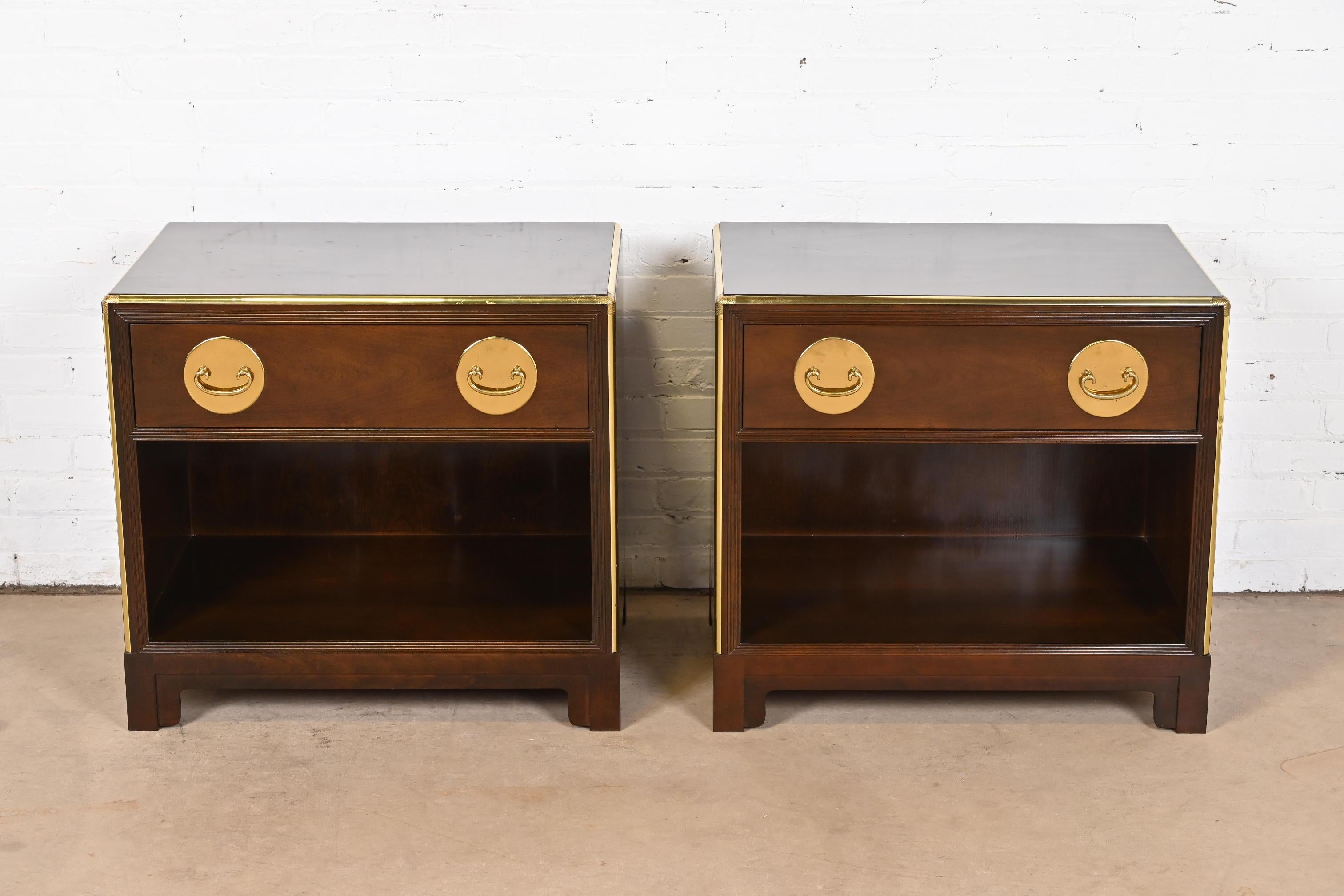 A gorgeous pair of mid-century modern Hollywood Regency Chinoiserie nightstands

By Michael Taylor for Baker Furniture

USA, Circa 1970s

Dark cherry wood, with original Asian-inspired brass hardware and brass trim.

Measures: 28