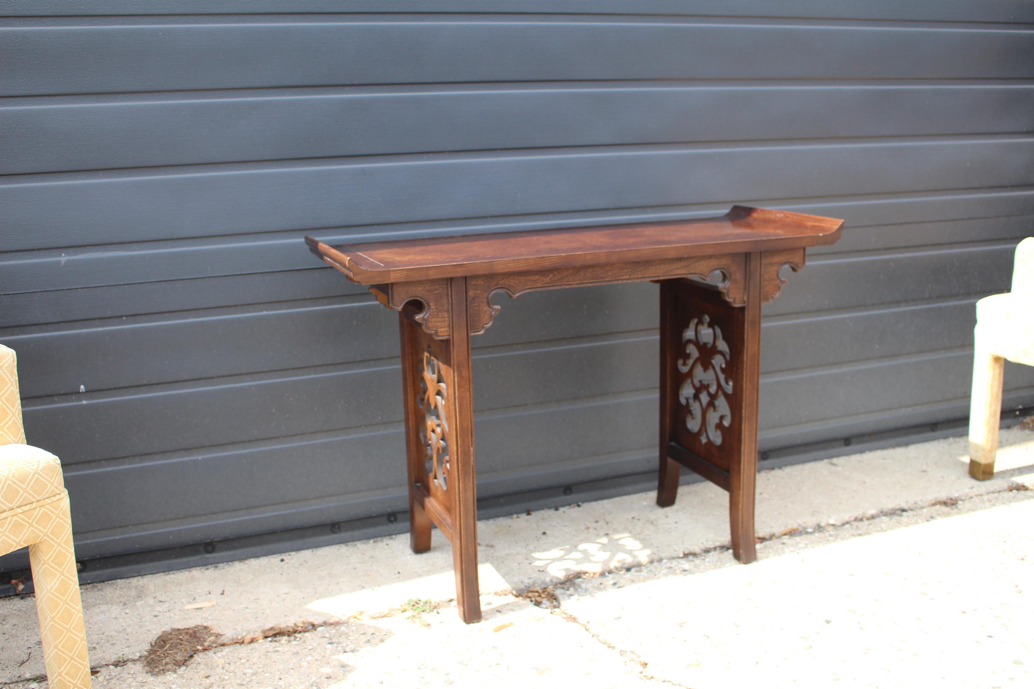 Mid-Century Modern Asian influenced Chinoiserie console or alter table.
Designed by Michael Taylor for Baker, circa 1960s. Versatile and functional piece can be used as
console, server, bar or media stand. Carved walnut with burl inlays on top.