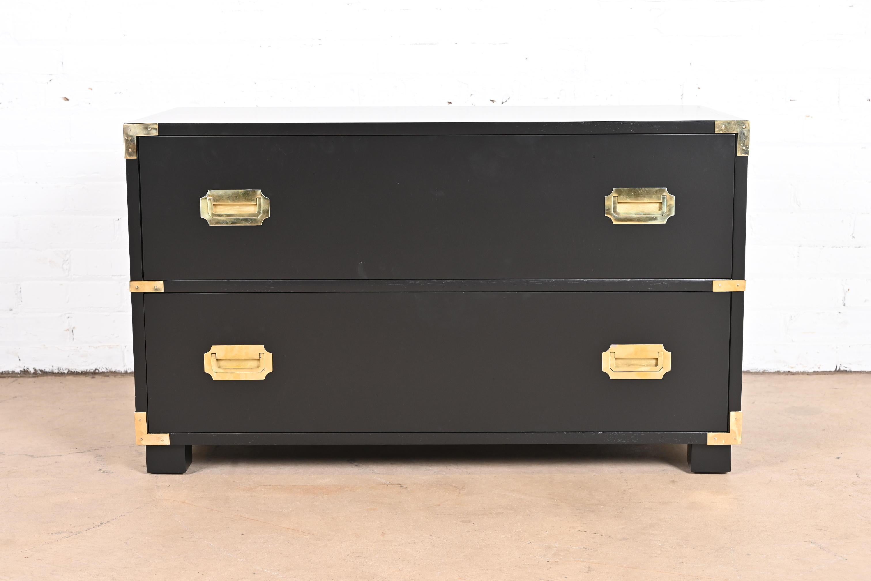 An exceptional mid-century modern Hollywood Regency Campaign style two-drawer lowboy dresser or chest of drawers

By Michael Taylor for Baker Furniture, 