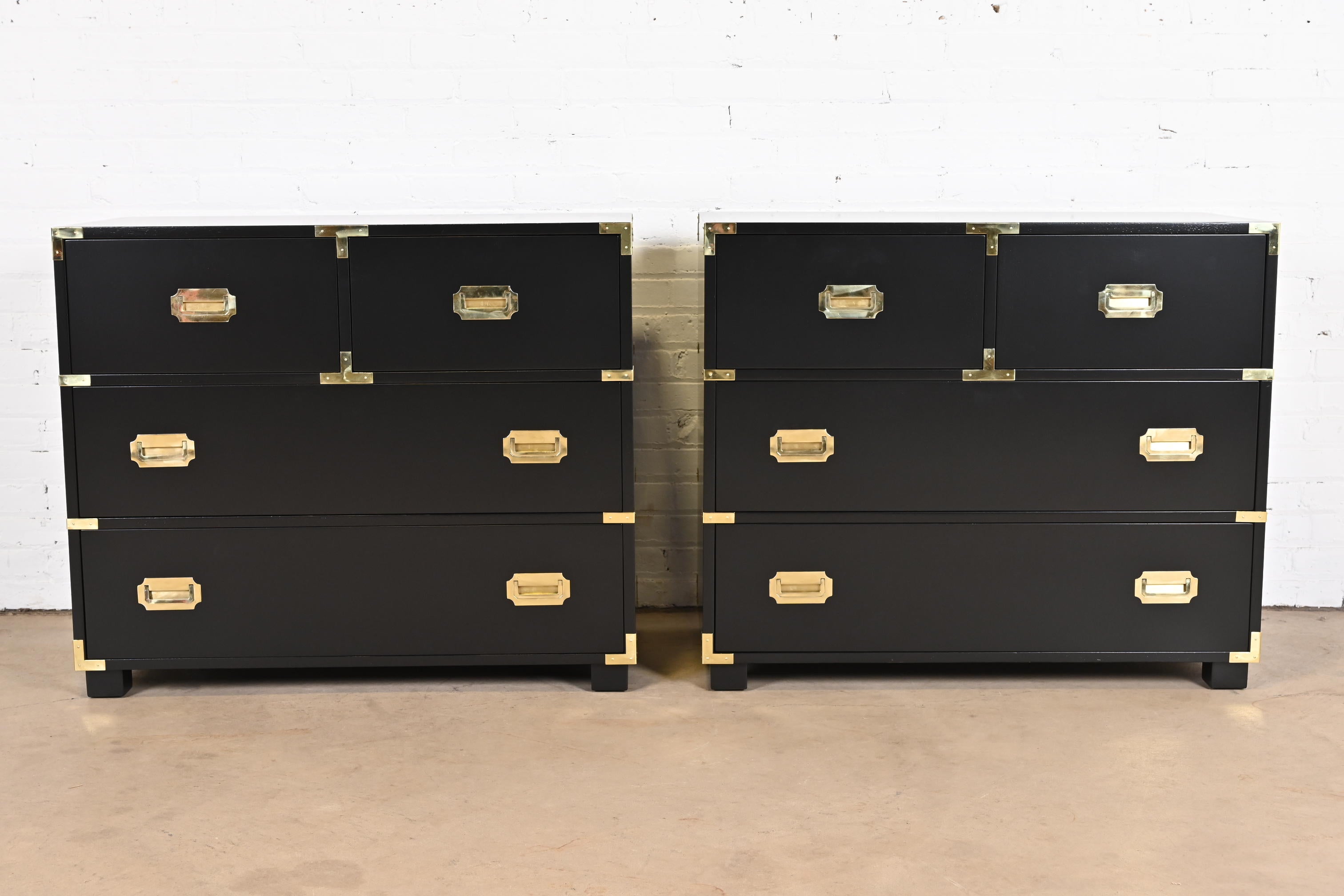 An exceptional pair of Mid-Century Modern Hollywood Regency Campaign style four-drawer dressers or chest of drawers

By Michael Taylor for Baker Furniture, 