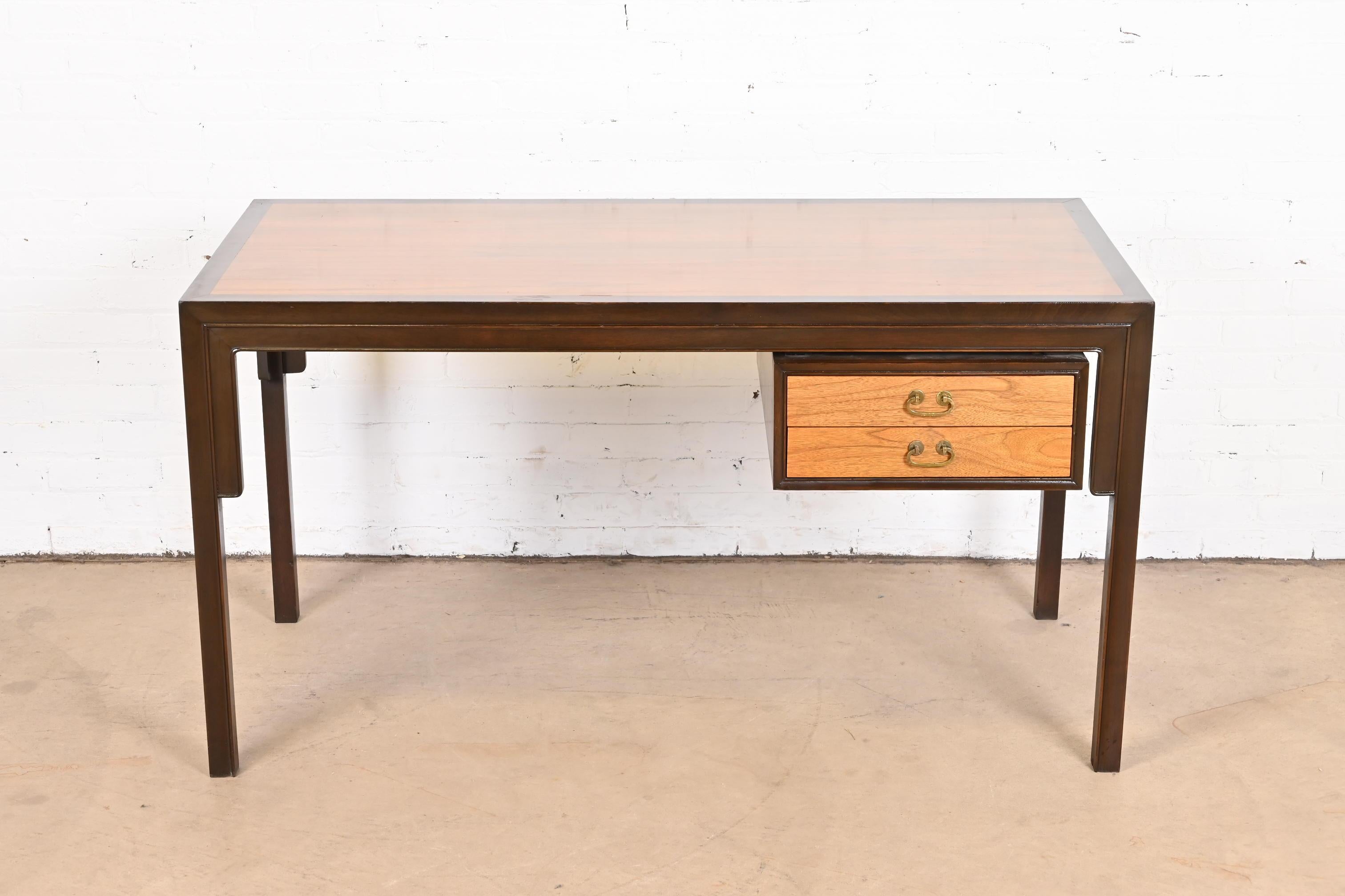 A gorgeous midcentury Hollywood Regency chinoiserie double sided partner desk

By Michael Taylor for Baker Furniture

USA, Circa 1960s

Carved walnut, with beautiful teak top and drawer fronts, and Asian-inspired brass hardware.

Measures: