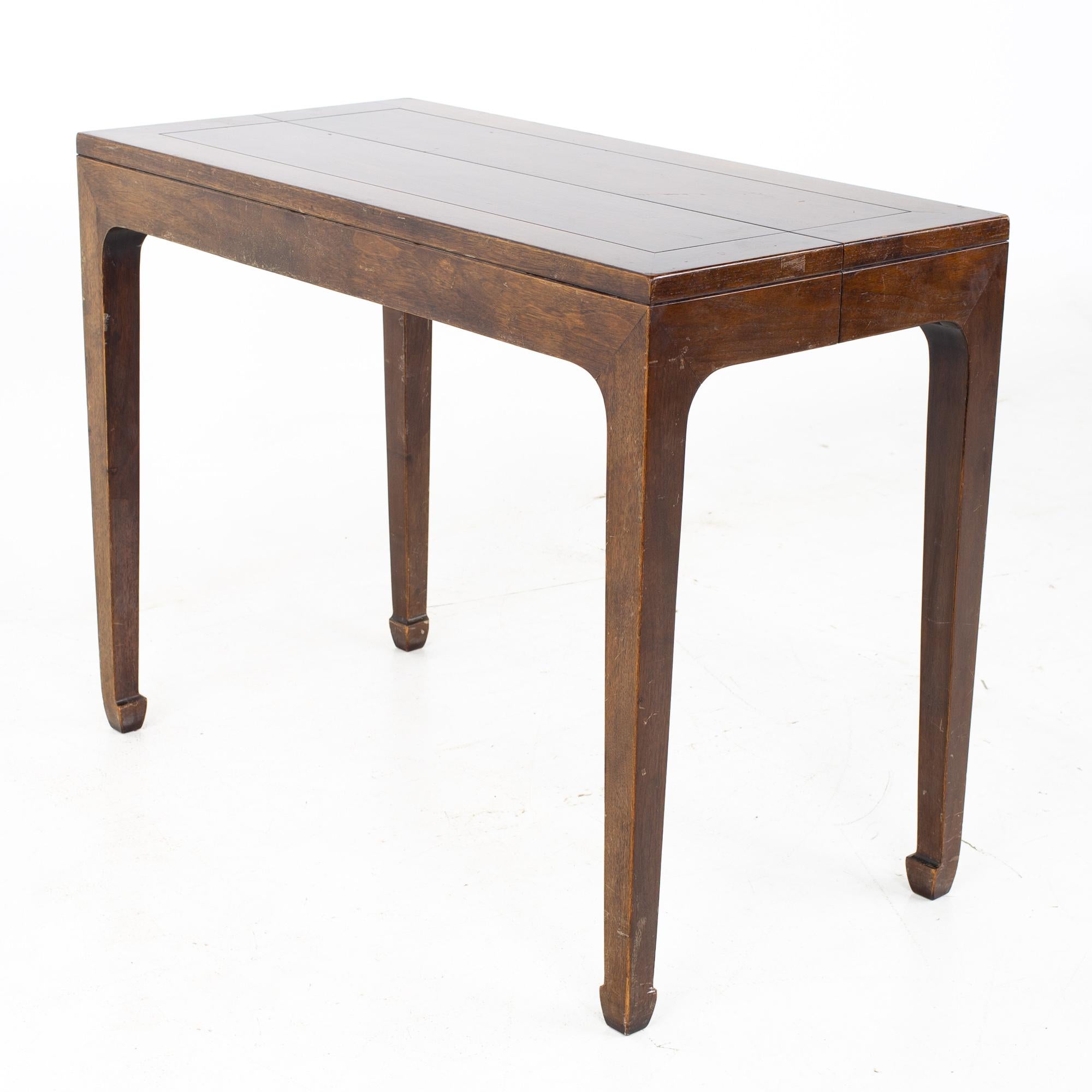 Michael Taylor for Baker mid century walnut expanding foyer entry console dining table
Table measures: 19 wide x 38 deep x 29 inches high; each leaf is 19 inches wide, making a maximum table width of 76 inches when all three leaves are used. There