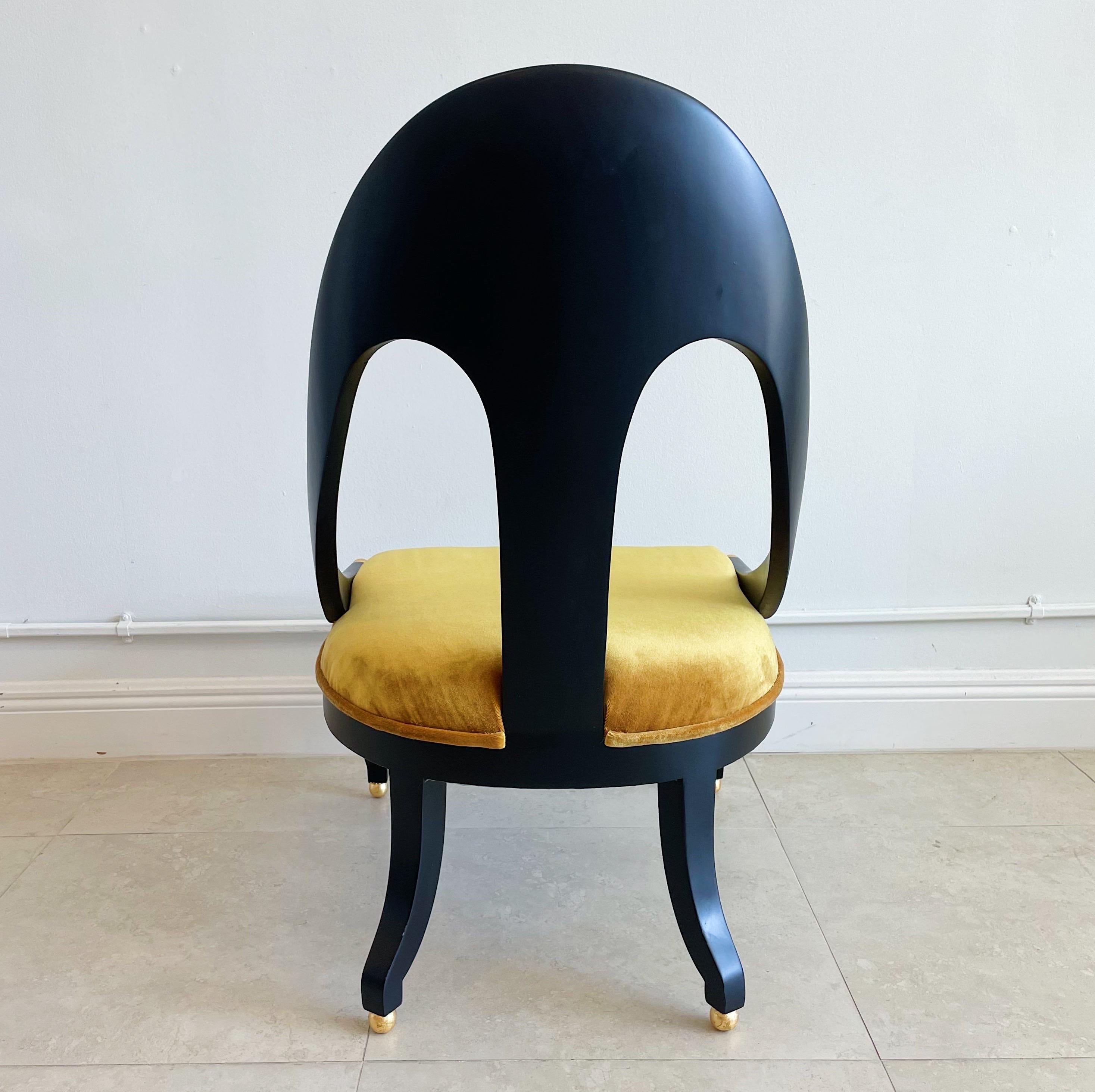 Delightful of slipper chairs by Michael Taylor for Baker Furniture Company. Newly refinished in 25% matte black lacquer with gold leaf accent balls on the feet and end of the arm rests. Recently upholstered in Mustard velvet over new foam and