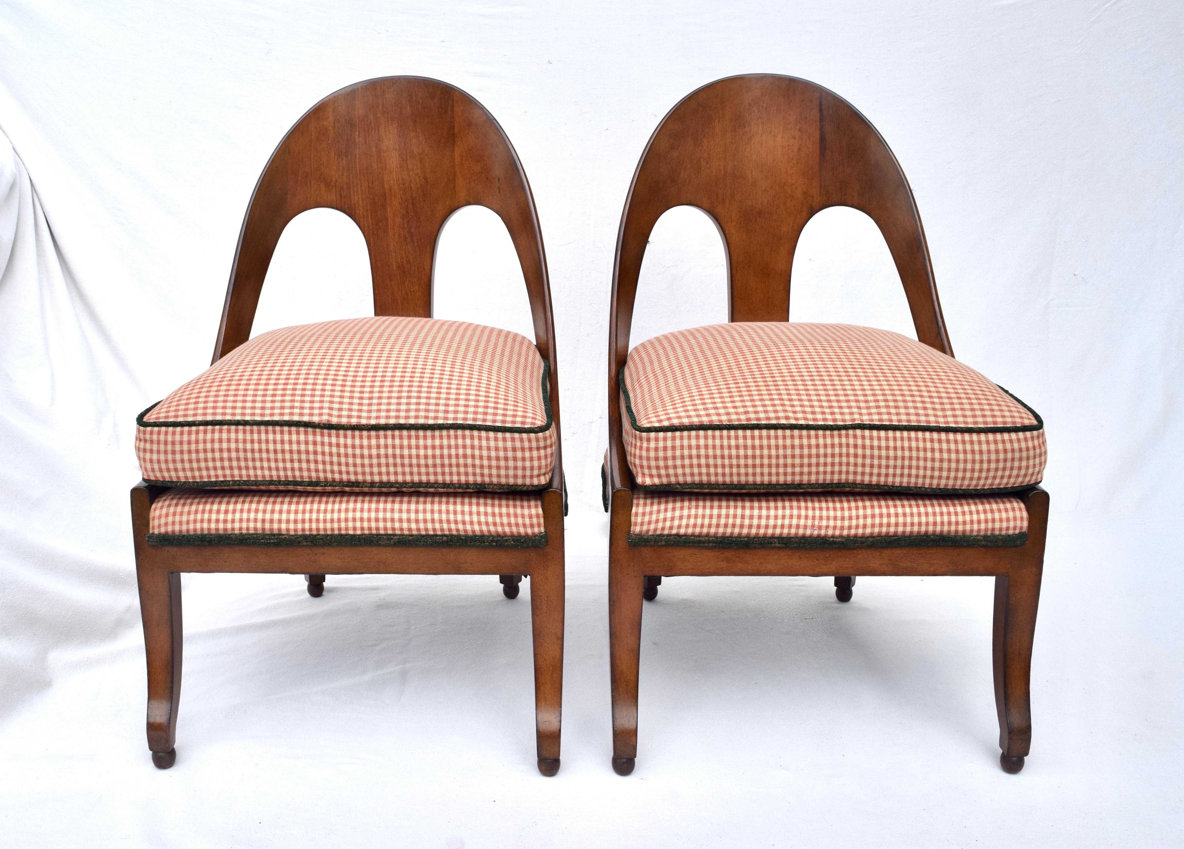 An early pair of Michael Taylor for Baker spoon chairs upholstered in red & tan windowpane cotton with dark green welt cord accents. We have modified the stationary seat design to include a single plump goose down filled cushion.