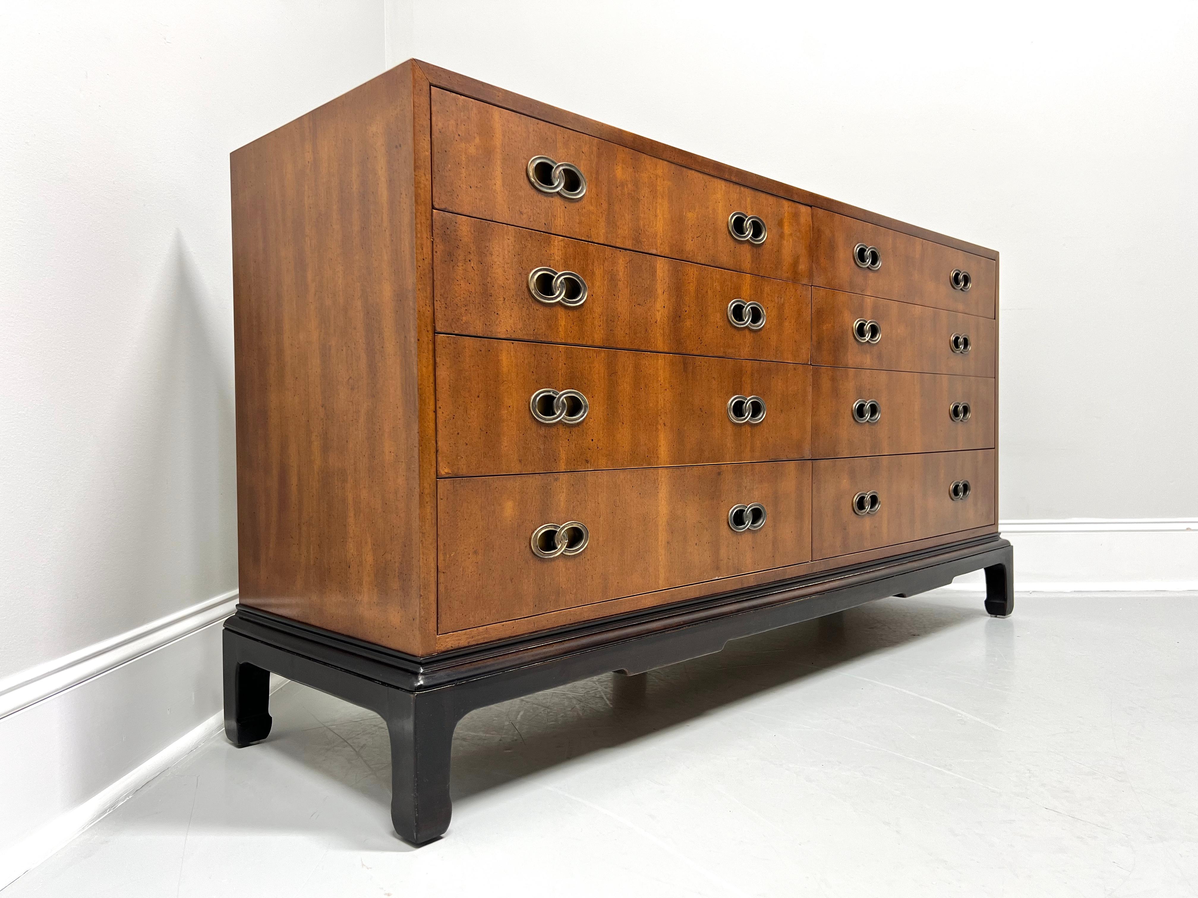 An Asian inspired double dresser designed by Michael Taylor for Henredon. Mahogany with a slightly distressed finish, decorative brass hardware, square edge to top, Ming design black lacquered base with curved inward square legs. Features eight