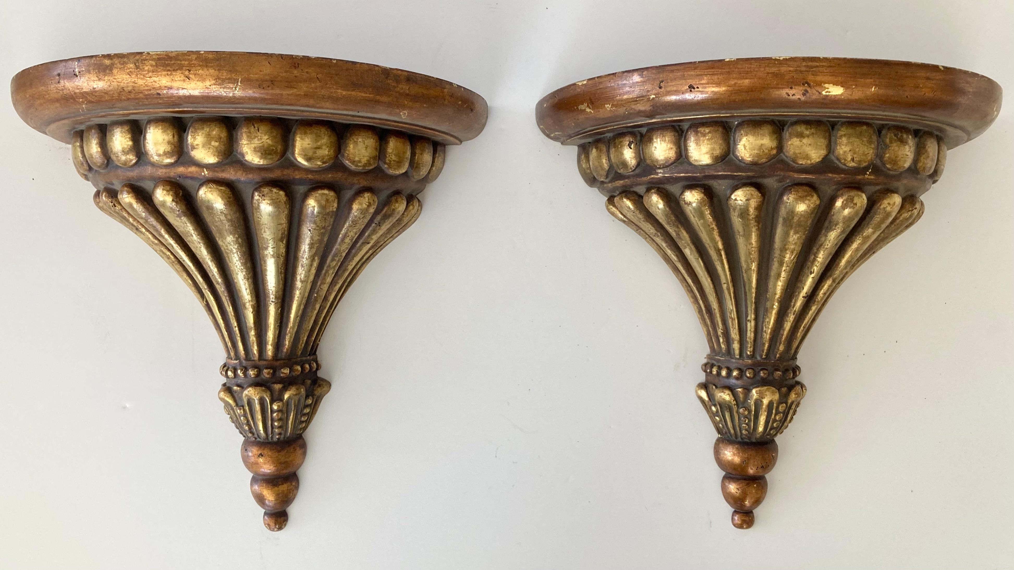 Pair of Michael Taylor gilt wall brackets. Gorgeous hand carved details and amazing gilt gold aged finish. Add some serious Michael Taylor style to your home.