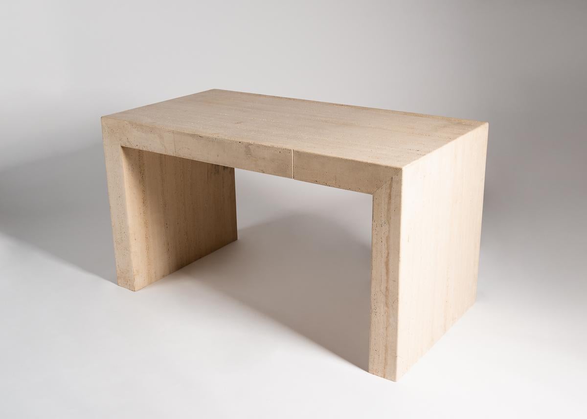 Rectangular travertine desk by American designer Michael Taylor.