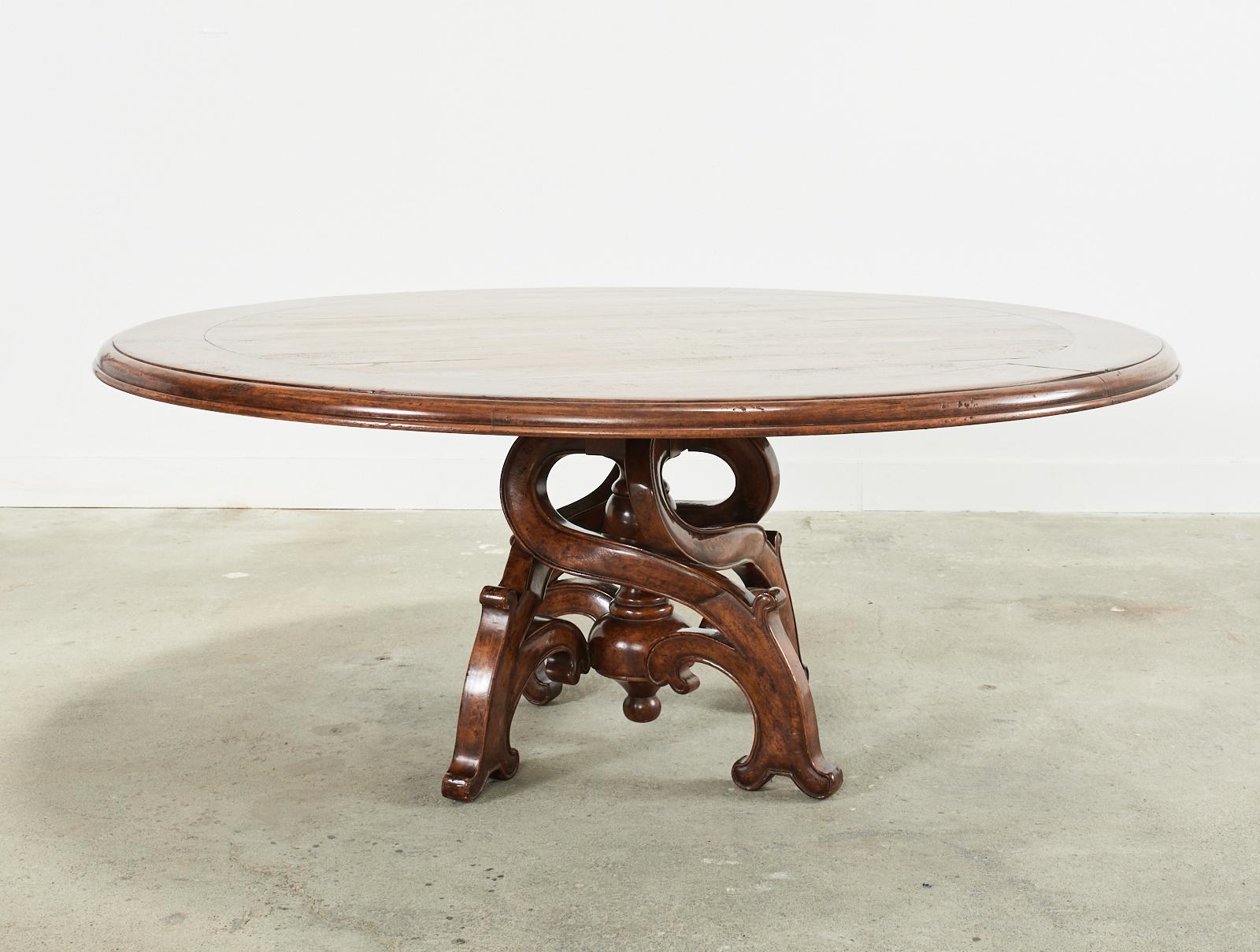 Stunning grand Barcelona baroque style round dining table by Michael Taylor Panache design. Model number # PAN-1257A is a 72-inch diameter round, four leg table featuring a spiral carved or intertwined leg pedestal base. Supporting a large plank top