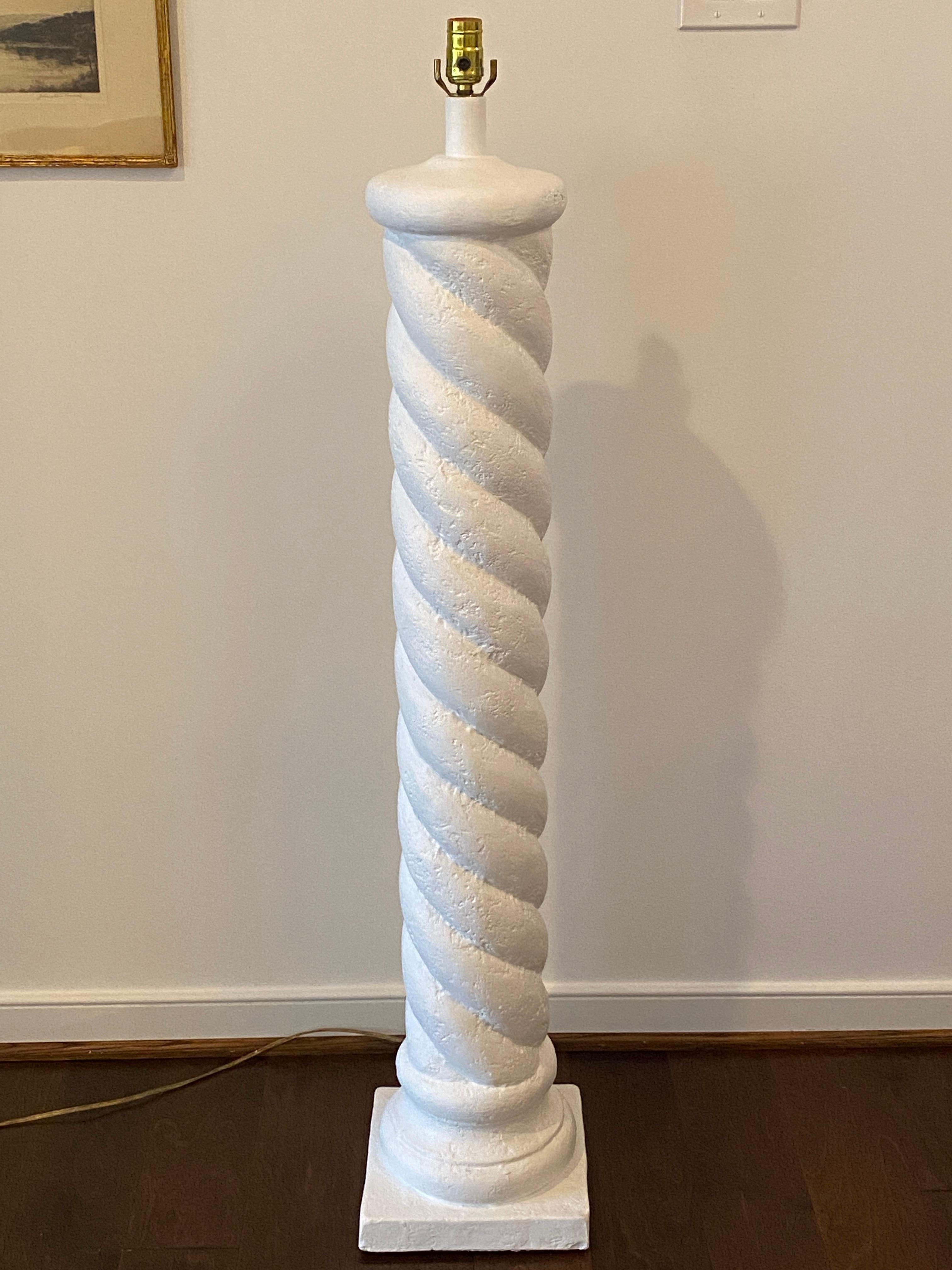 Listed is a substantial, plaster spiraled column floor lamp in the style of Michael Taylor, circa 1970s. The piece has been professionally painted a flat white. Heavy, weighing an astounding 33.5lbs. No shade included.