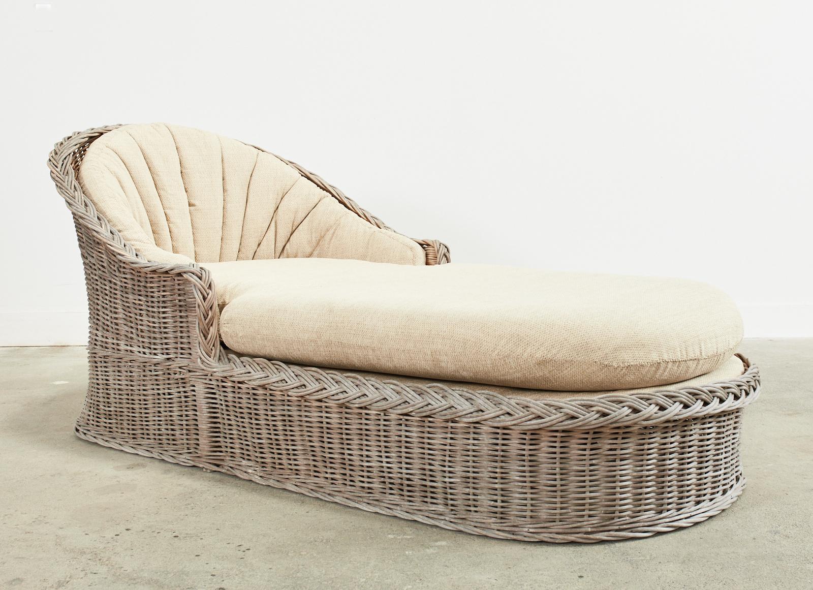 Large organic modern Michael Taylor style chaise longue or lounge by The Wicker Works San Francisco, CA. The lounge features a rattan frame covered with woven rattan wicker having a decorative braided border. The chair is oversized with a generous