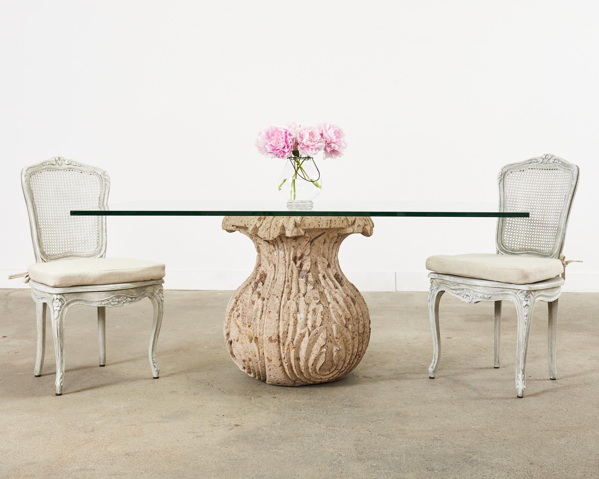 Imposing molded stone patio and garden dining table featuring a tulip shaped bulbous formed base decorated with acanthus in the neoclassical taste. The base is very heavy with an organic bell-shaped form that flares out on the top. Beautifully