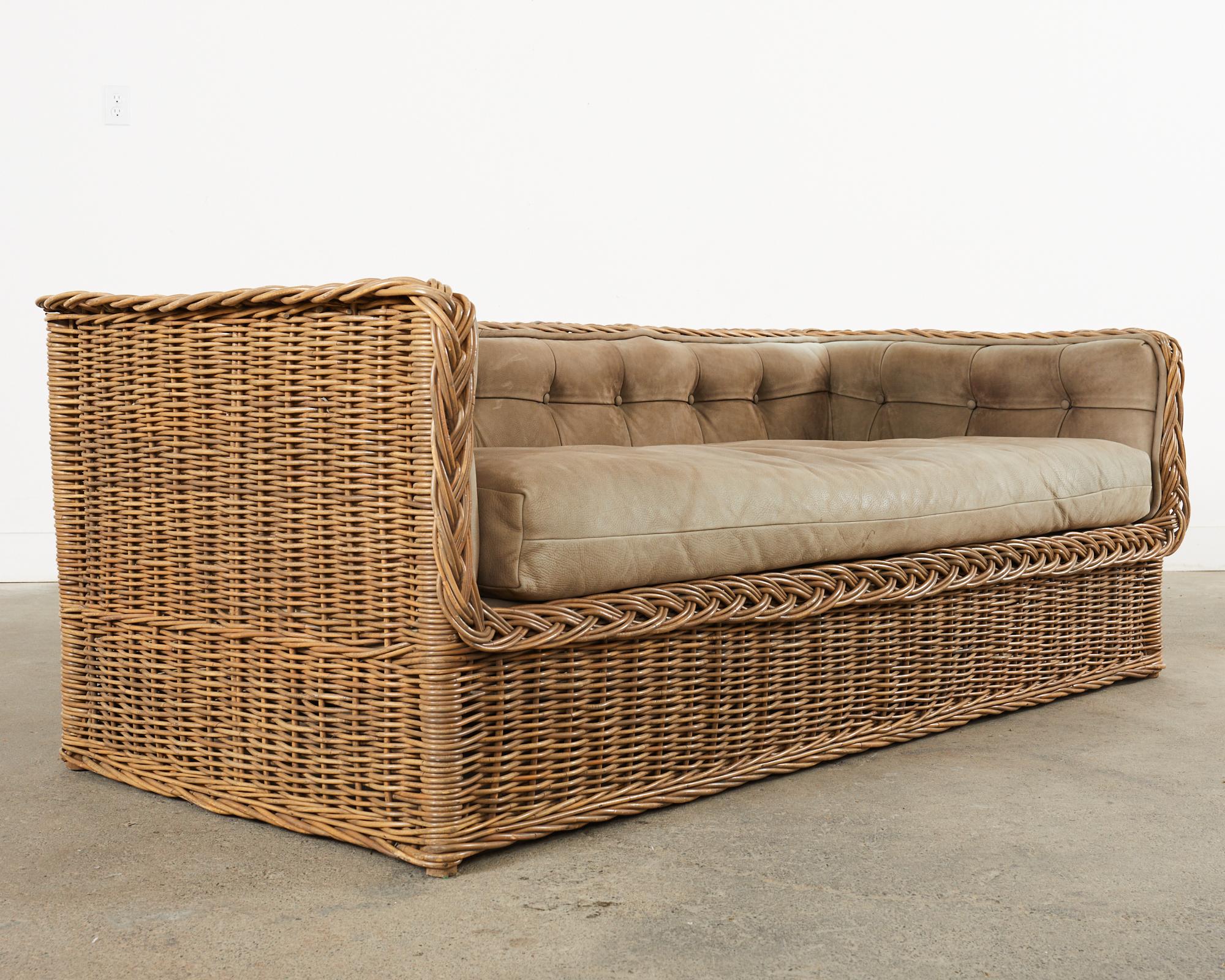 Organic modern daybed sofa crafted from woven wicker rattan in the manner and style of Michael Taylor. Beautifully crafted by Wicker Works San Francisco, CA. The sofa was custom ordered with an optional tufted leather trim and thick loose seat