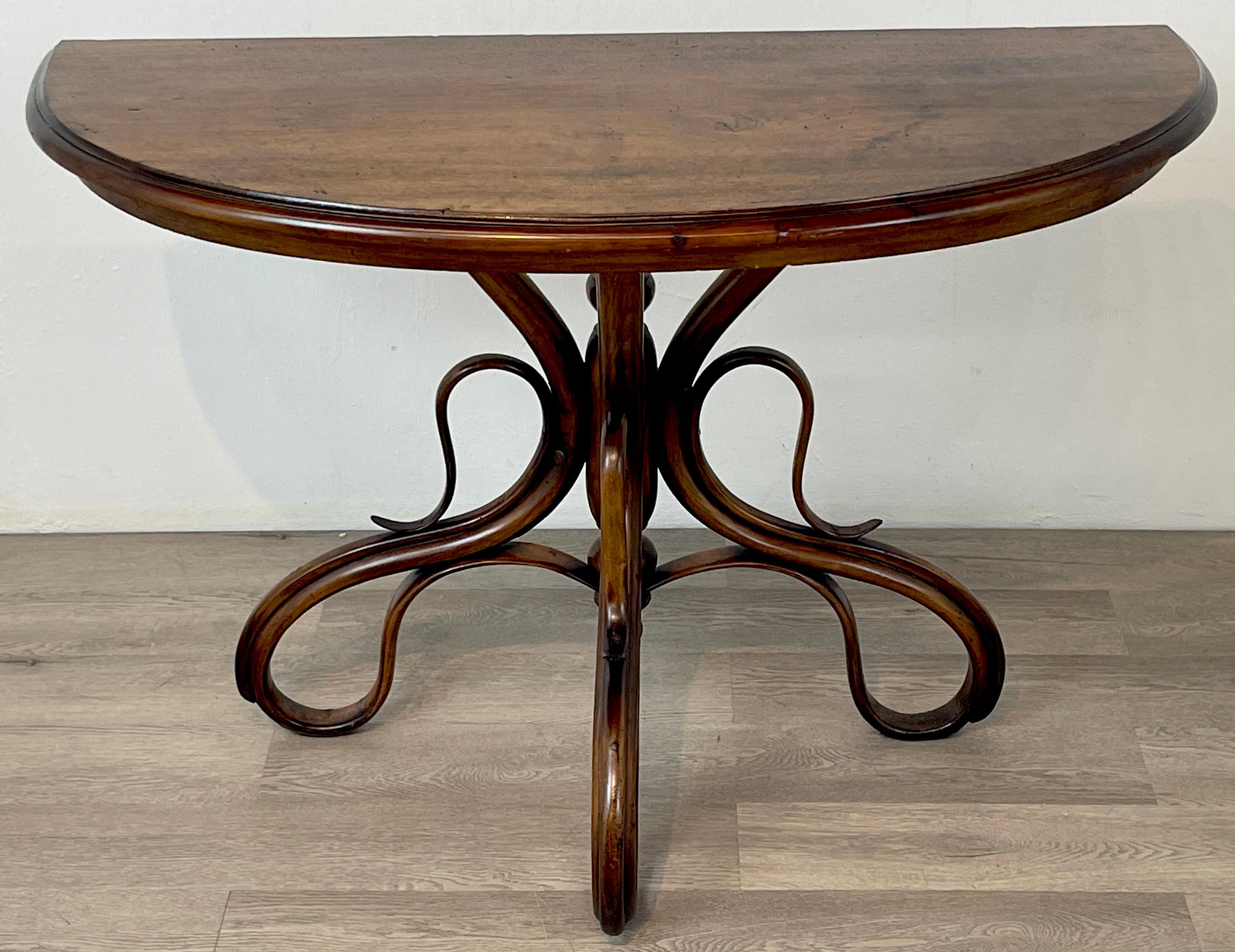 Michael Thonet bentwood console table
Austria Circa 1880s
A Fine example, of typical demilune form, raised on a tripartite pedestal base of stained steam-bent pine. 
Unmarked. 
The overall dimensions of the table are 43-Inches wide x 18-Inches