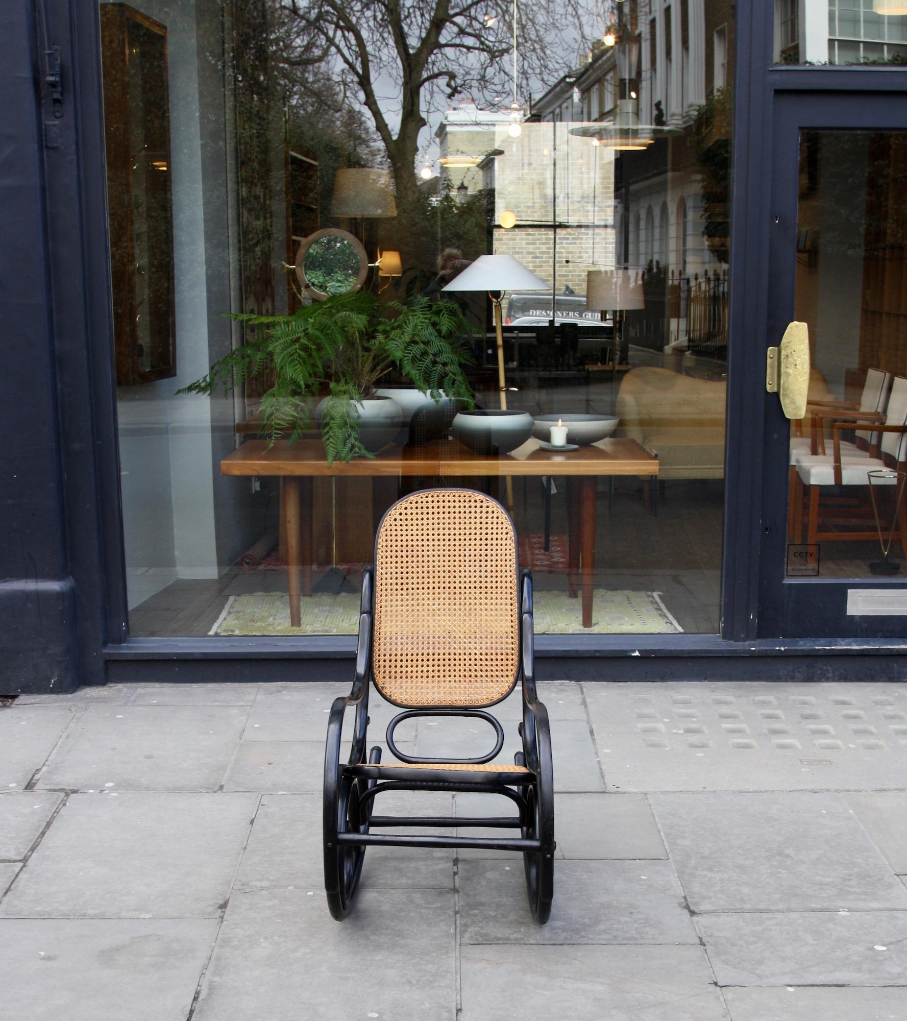 A vintage No.10 bentwood and cane rocking chair in black lacquer by Thonet, Austria.
The Model No.10 rocking chair was designed by Michael Thonet, circa 1860-1890, this example dates from circa 1900. The chair features a generously sized handwoven