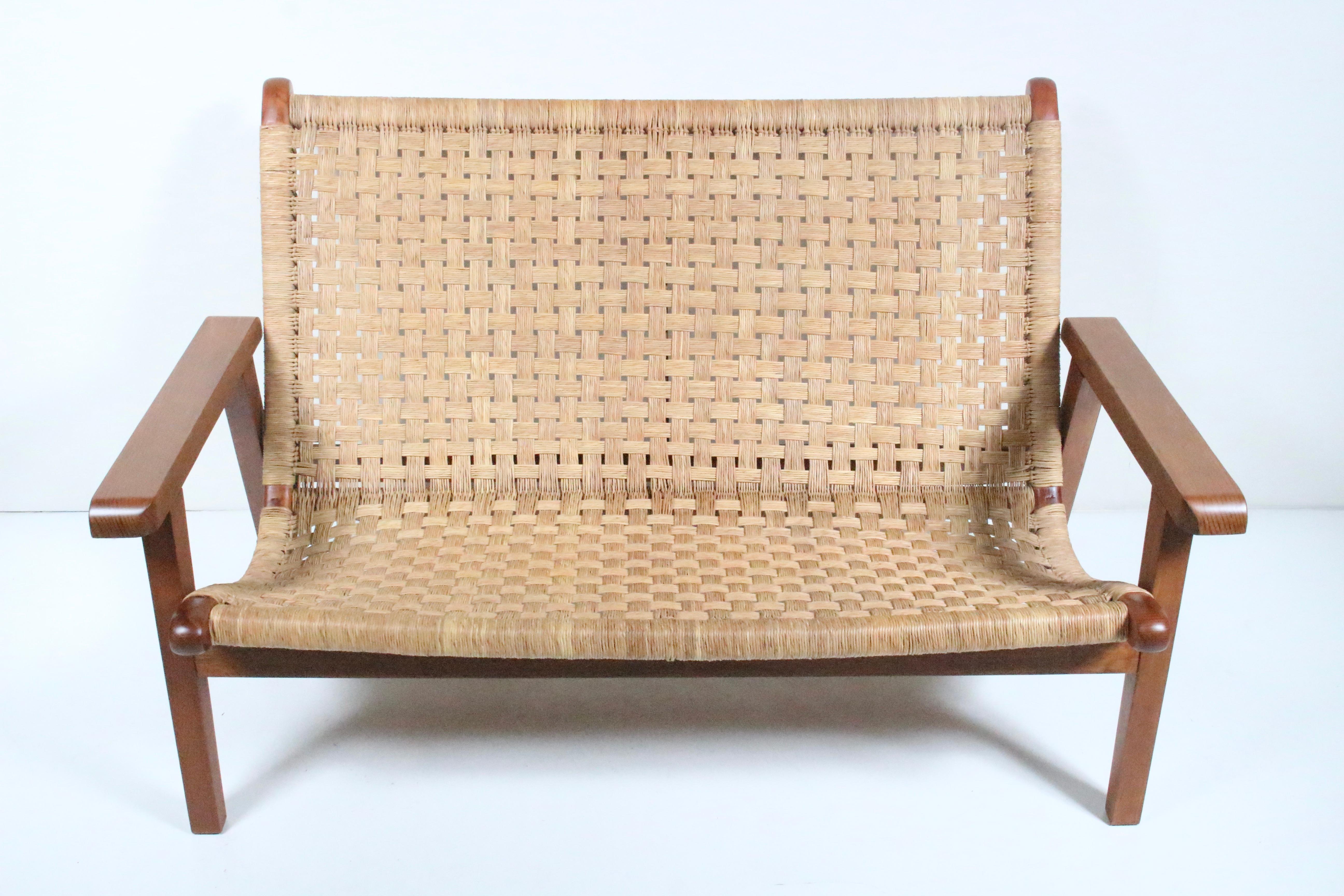 Mexican Modern Michael van Beuren teak and woven raffia lounge settee. Featuring a sturdy, functional, with comfortable two piece Teak framework, two pegs to hold the seat in place, and Raffia wrapped rounded back and seat strung in a soft