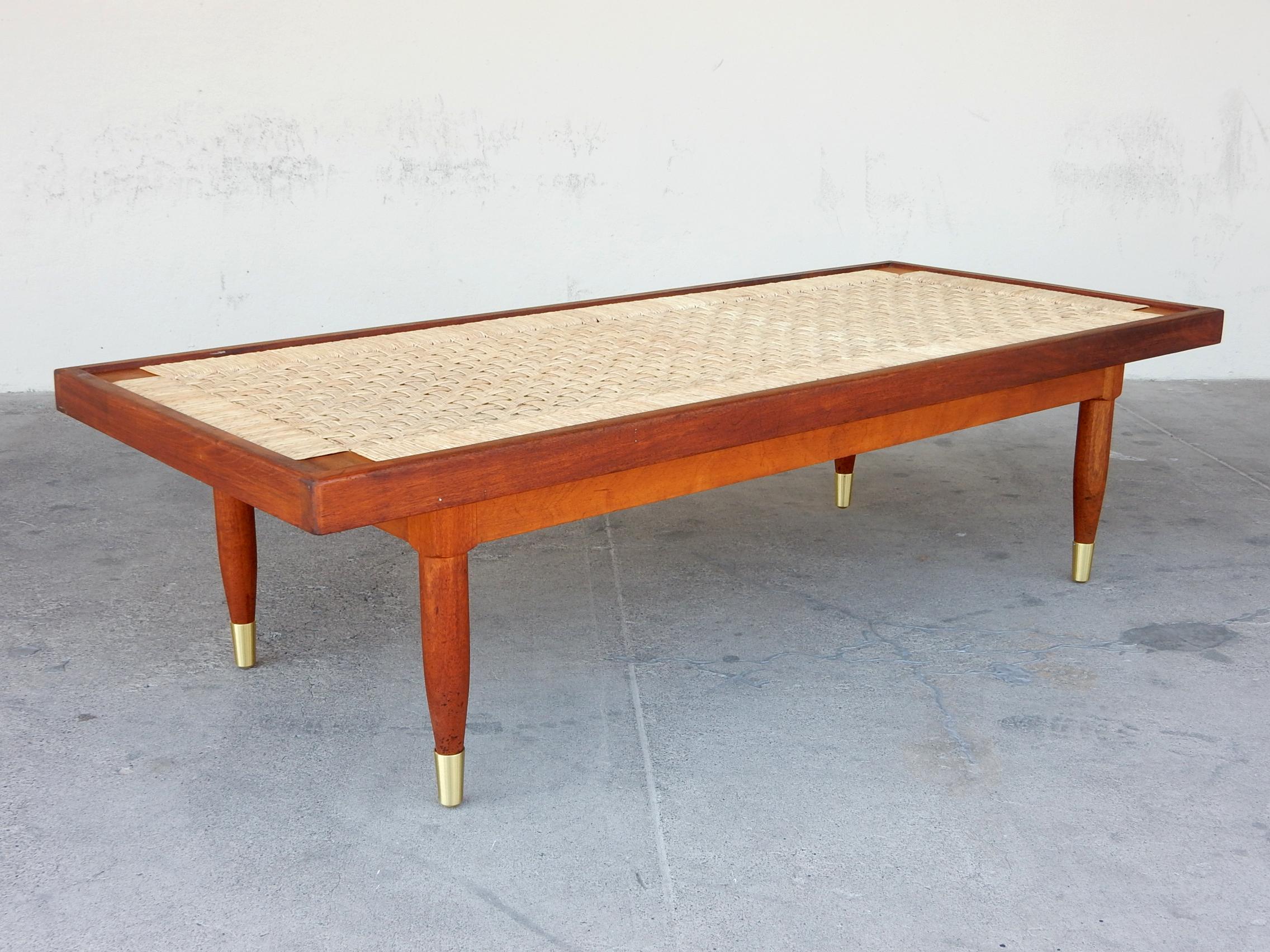 Attributed Michael van Beuren design coffee table, Mexico, circa 1950's.
2-tone hardwood frame with
an under-frame strung with rattan, woven in a
multi-strand basket weave resembling a checkerboard.
An inset piece of glass brings the table