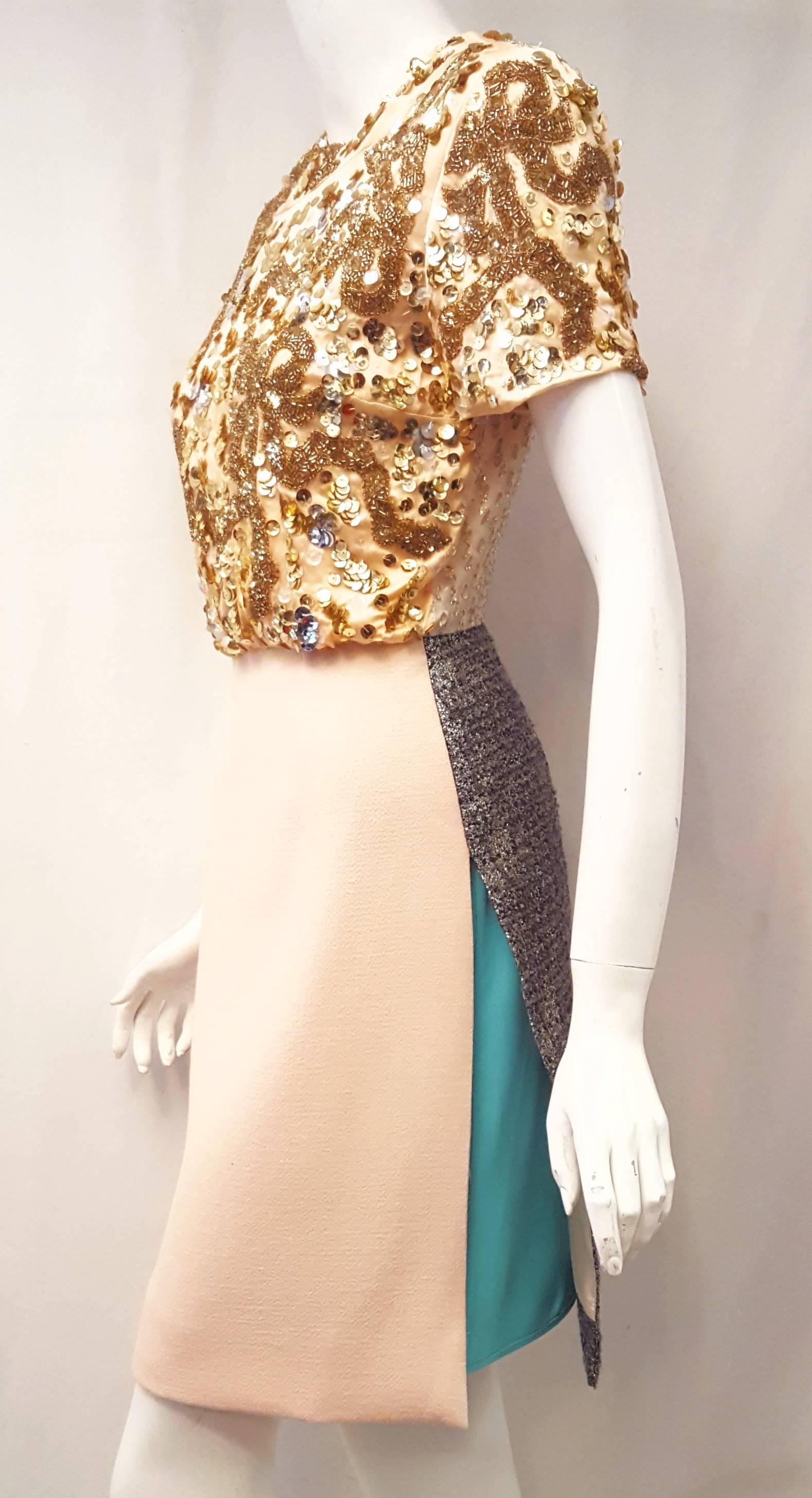 Michael Van Der Ham multi fabric silk, wool, viscose & polyester and multi color short sleeve dress is very imaginative and unusual.  At the front of the dress, the top is gold sequined including the sleeves and the skirt is a beige single panel. 