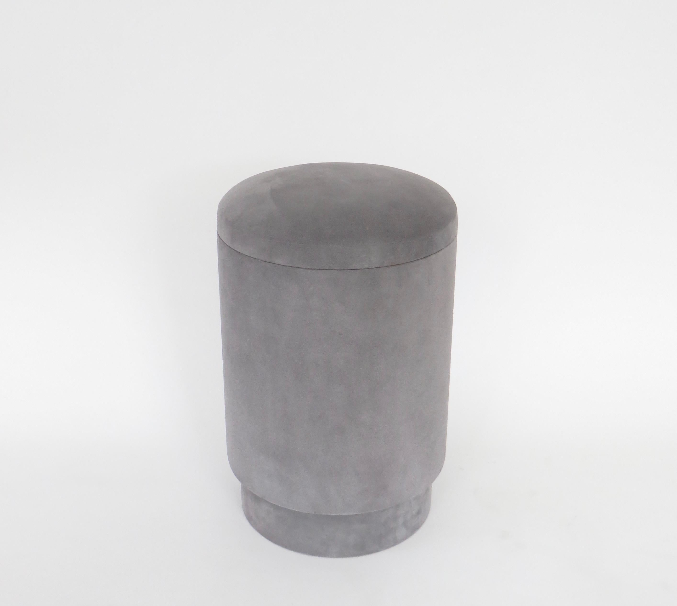 A Michael Verheyden pouf or tabou or stool with storage available in various colors. Shown is the color light gray. 
Pouf with storage space is covered in the most beautiful suede. The interior is lined in black suede. 
Michael Verheyden is a