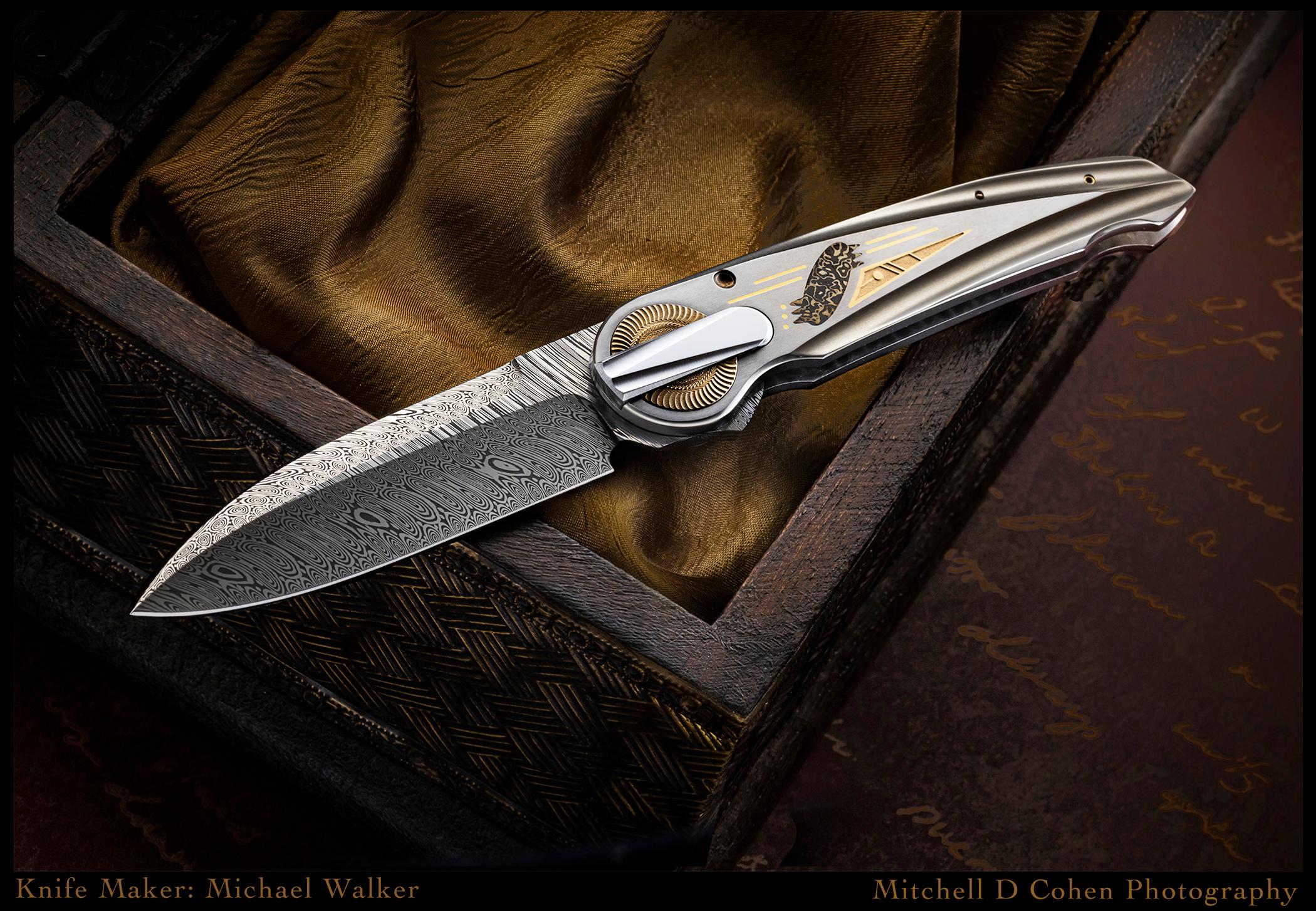 Michael Walker Custom Knife, D-Lock, third generation from AKI. 22K gold inlays and the other inlay is shakudo/silver mokume. Shakudo is an alloy of copper and gold and patinas black. Titanium handles stainless damascus blade.
6-3/4