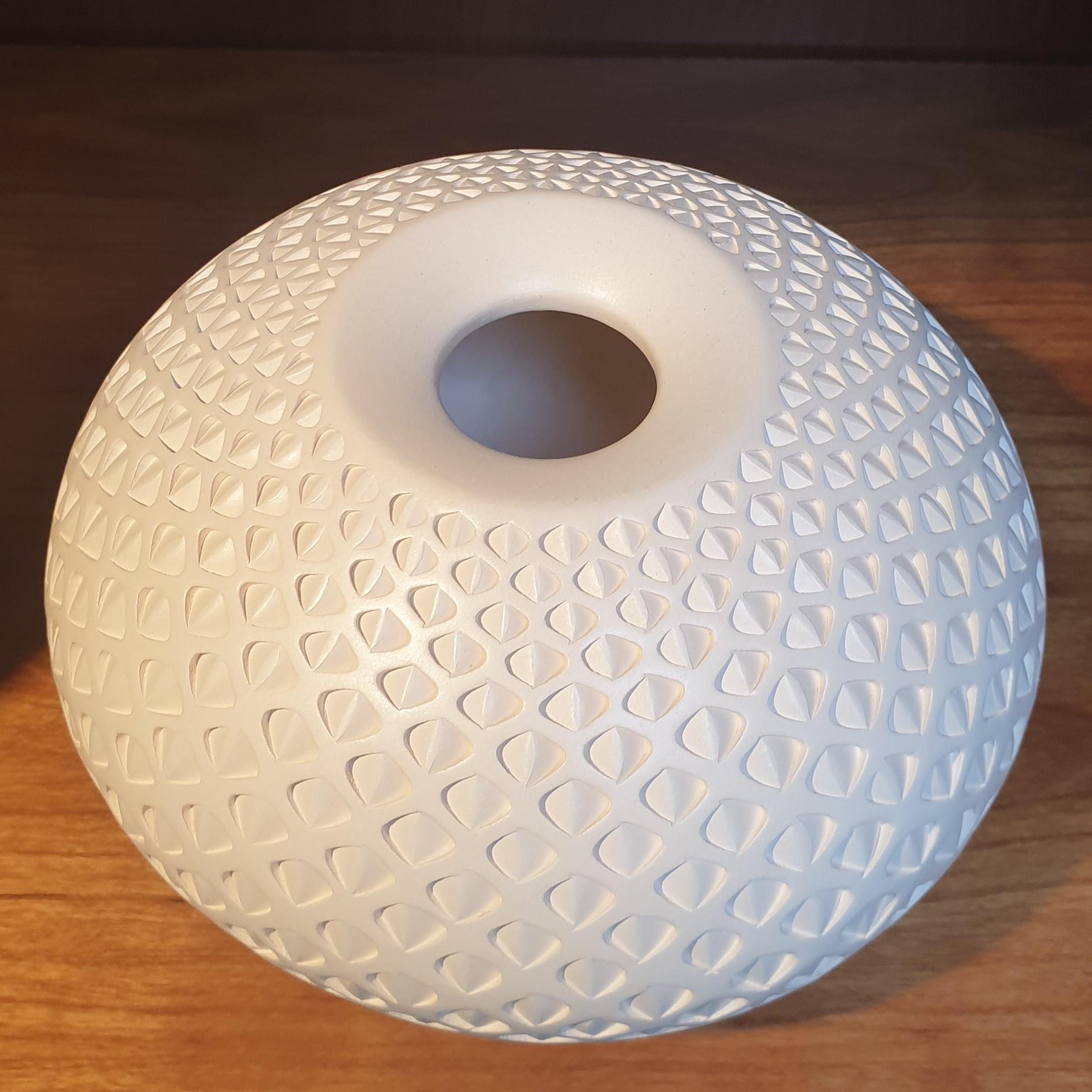 This off-white Oval Eye Vessel is a unique small size contemporary modern ceramic vase shaped vessel by US-artist Michael Wisner. The hand-coiled shape of this object is simple but very elegant, complementing the intense patterning made through a