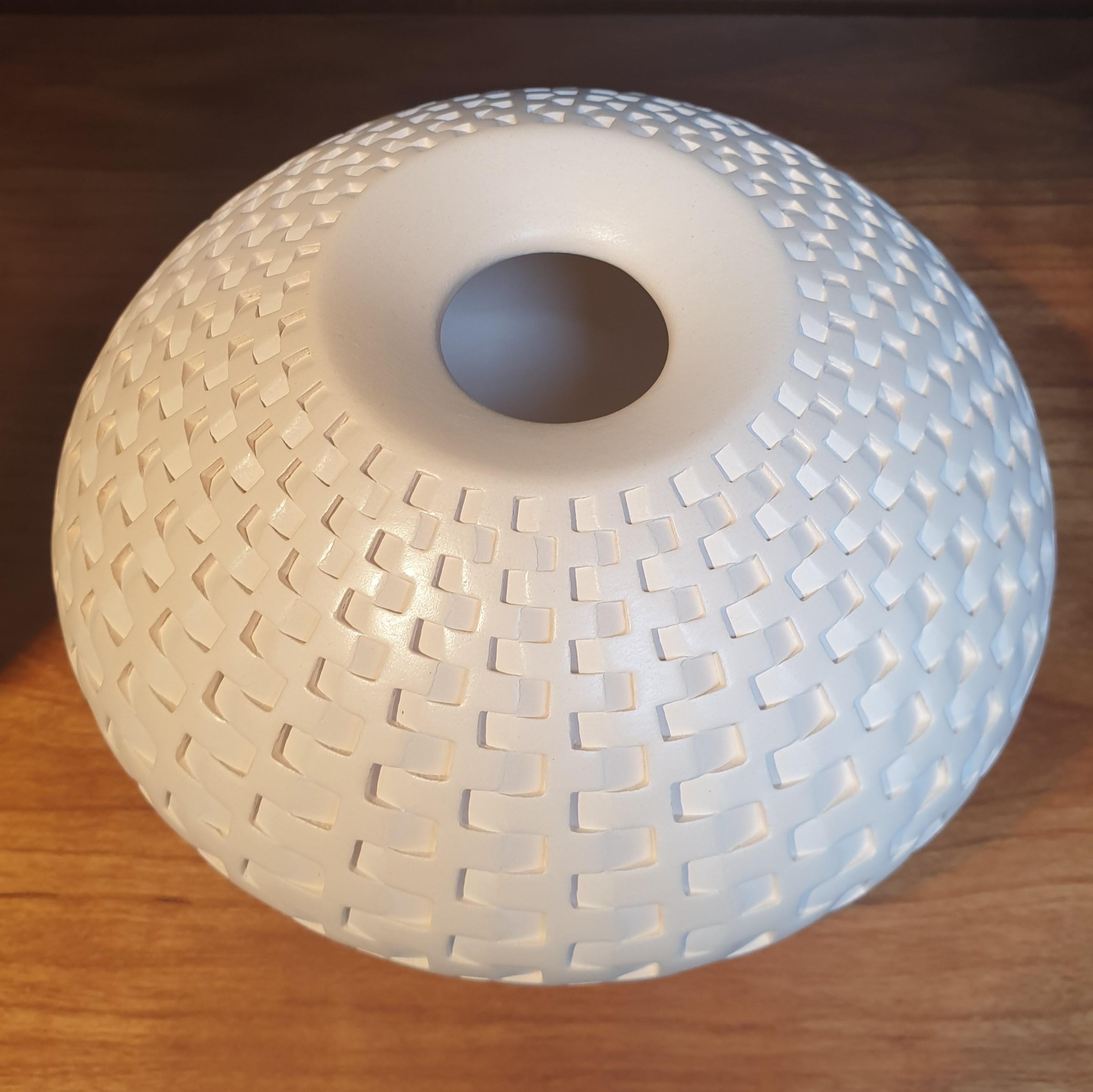 This off-white Rattan Vessel is a unique small size contemporary modern ceramic vase shaped vessel by US-artist Michael Wisner. The hand-coiled shape of this object is simple but very elegant, complementing the intense patterning made through a very