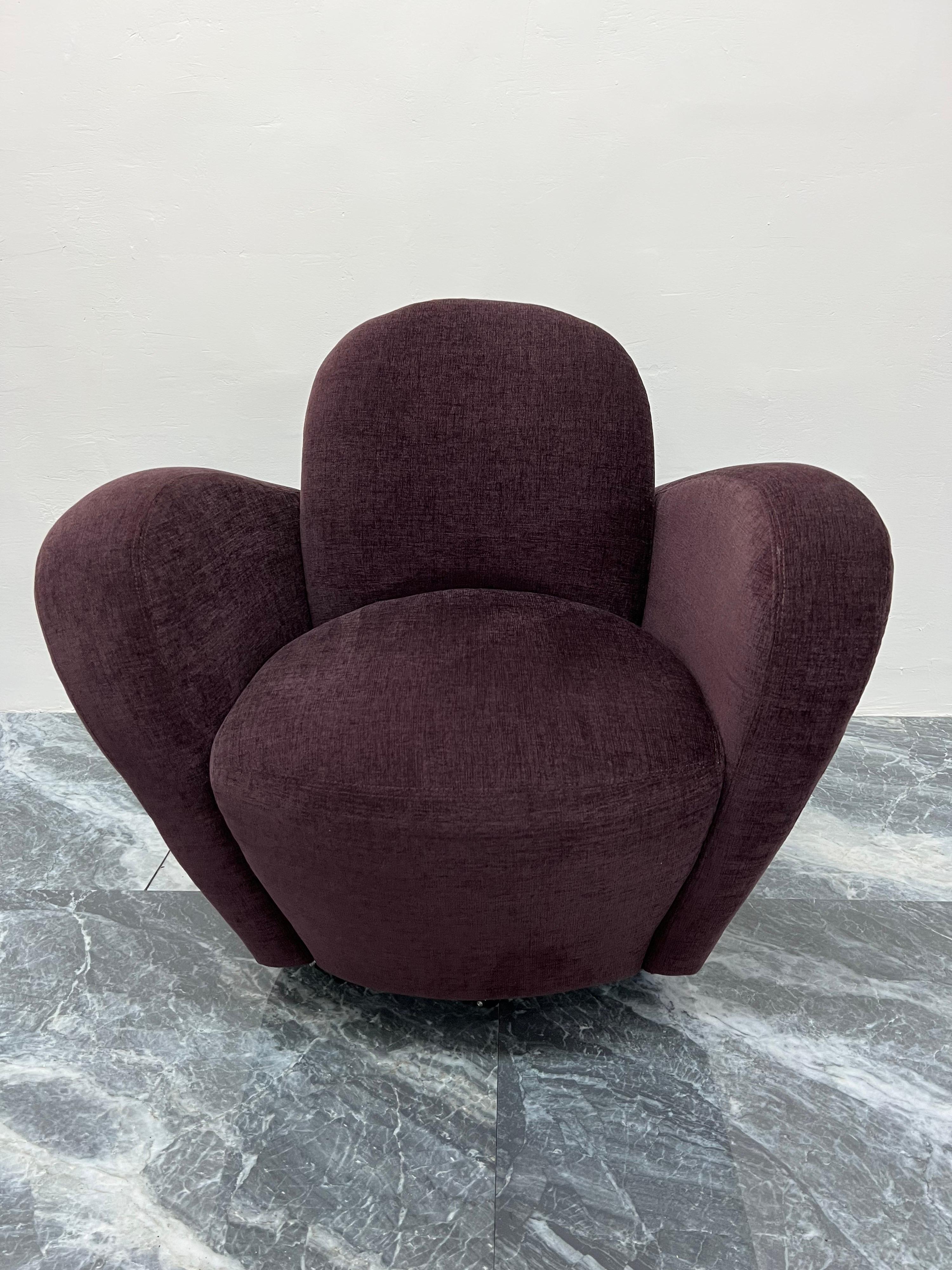 Iconic Michael Wolk designed Miami lounge chair. The chair sits on five casters and maintains its original Eggplant upholstery which is in excellent condition for age and use.

While driving through Coconut Grove, Florida in the early 1980s, Wolk