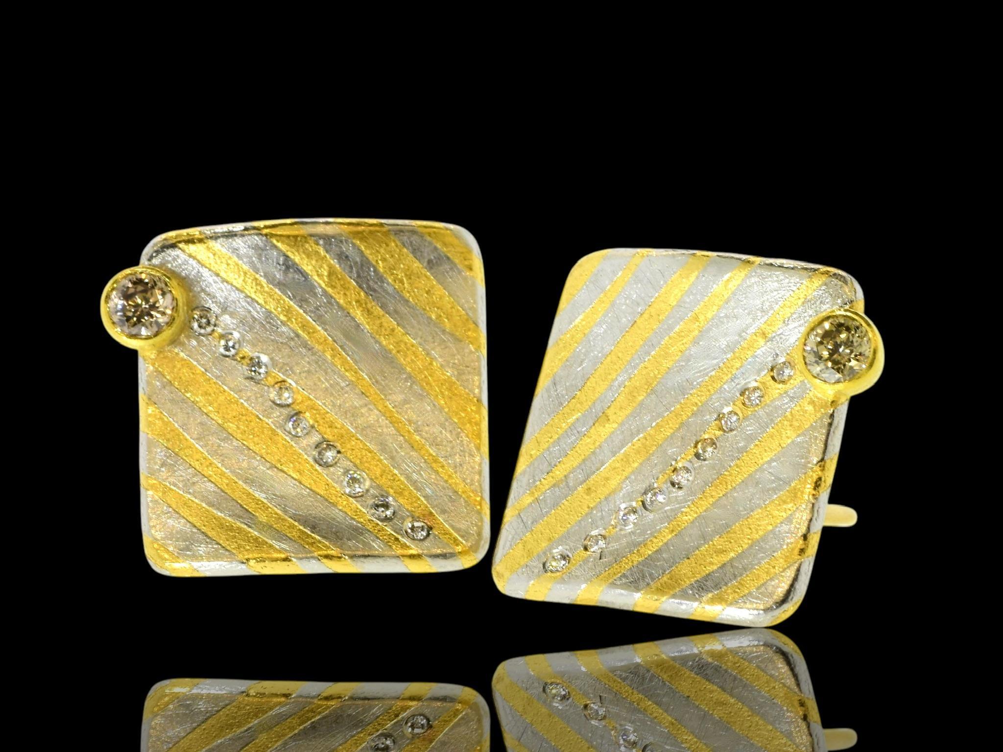 Michael Zobel 18K yellow gold, oxidized sterling silver with both white and colored diamonds, c. 2001. These hand crafted earrings by the world famous designer, Michael Zobel are both 18K yellow gold and sterling silver. The earrings are marked 750