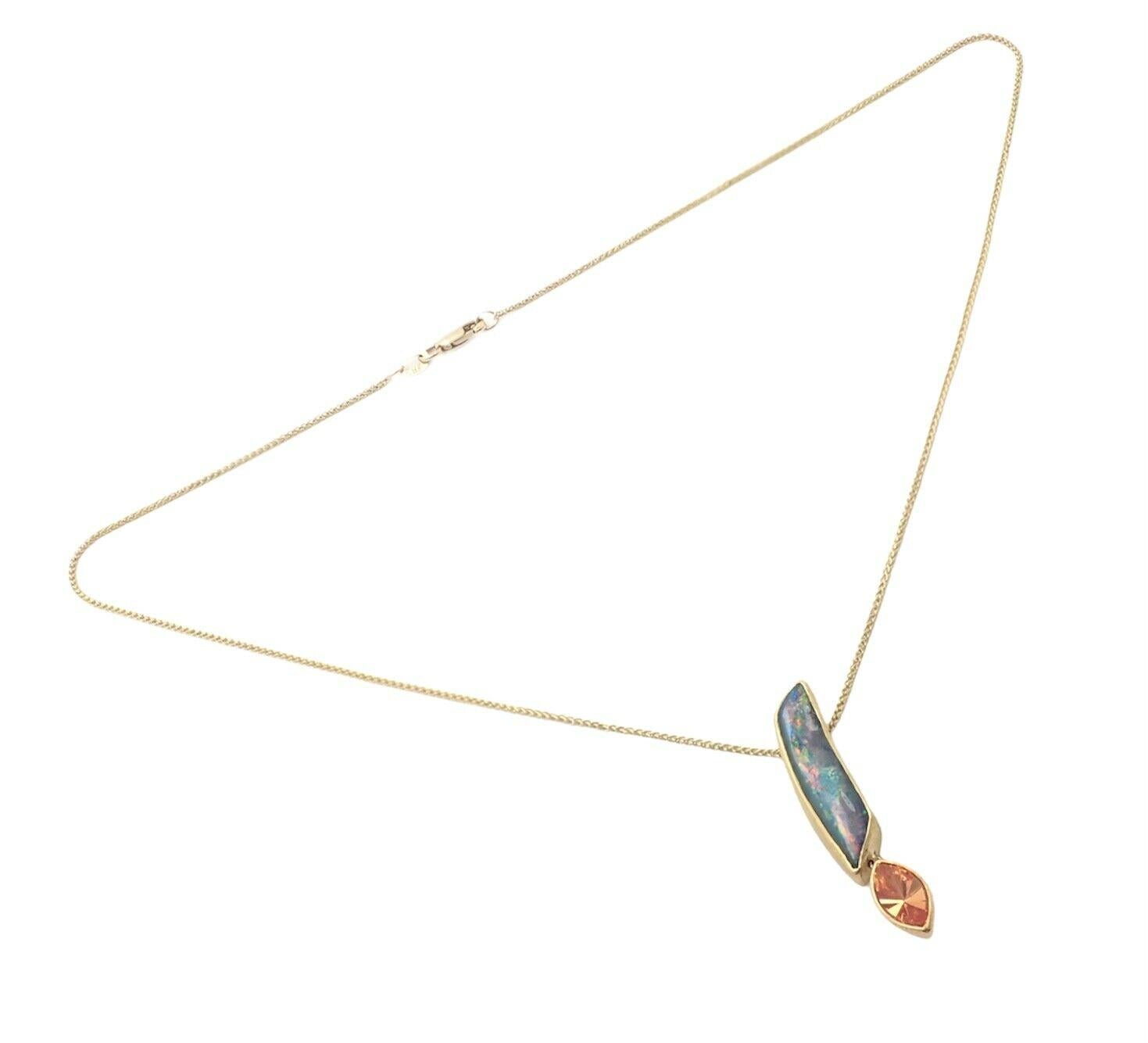 18k Yellow Gold Black Opal Orange Spessartite Necklace By Michael Zobel.
With 1 Black Opal: 5.5mm x 23mm and 1 Orange Spessartite Garnet - 9.5mm x 5mm x 3mm Estimated Weight 0.89ct

 Details:
 Length: 15.75