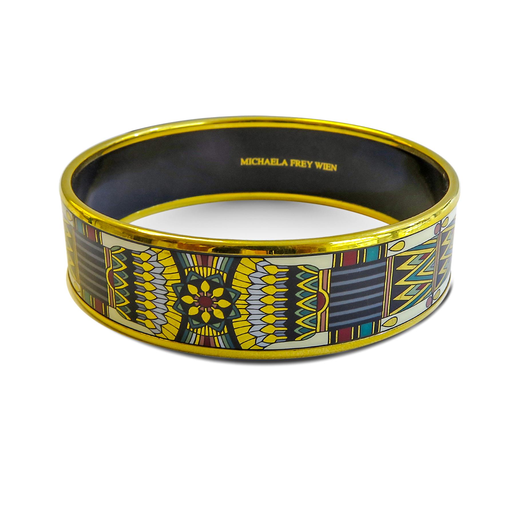 Like every Michaela Frey Wien products, this pure art. This bangle features an 18 Karat gold plated with a printed enamel. Carved in Austria, It weighs 44.5 grams, 20mm wide and has an inner diameter of 2.7 inches to give a comfortable fit in your