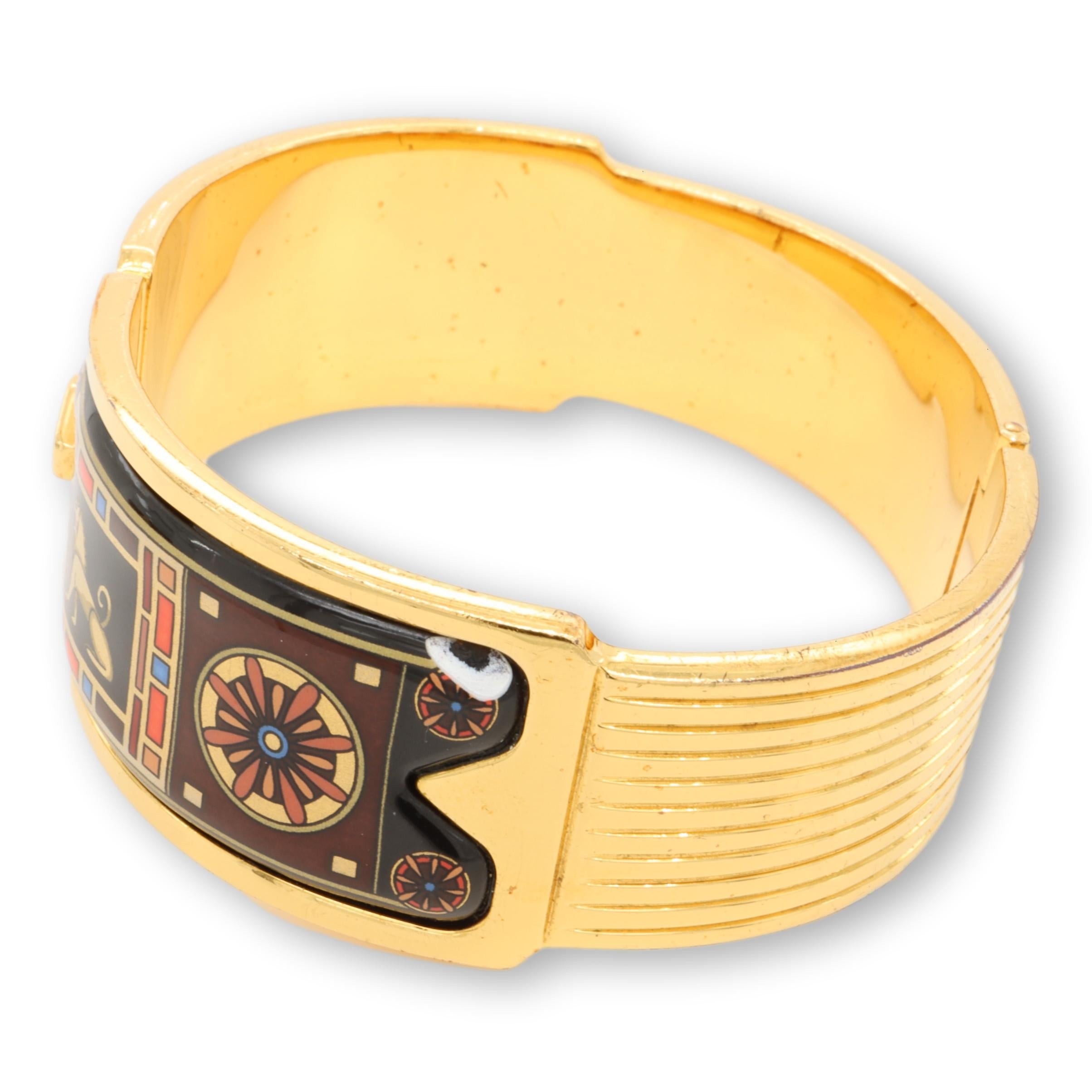 Vintage Bangle bracelet designed by Michaela Frey Wien finely plated in 24 karat gold fill with a colorful mix of enamel with a gold lion design with black blue, red and orange patterns. Measures  6 1/2