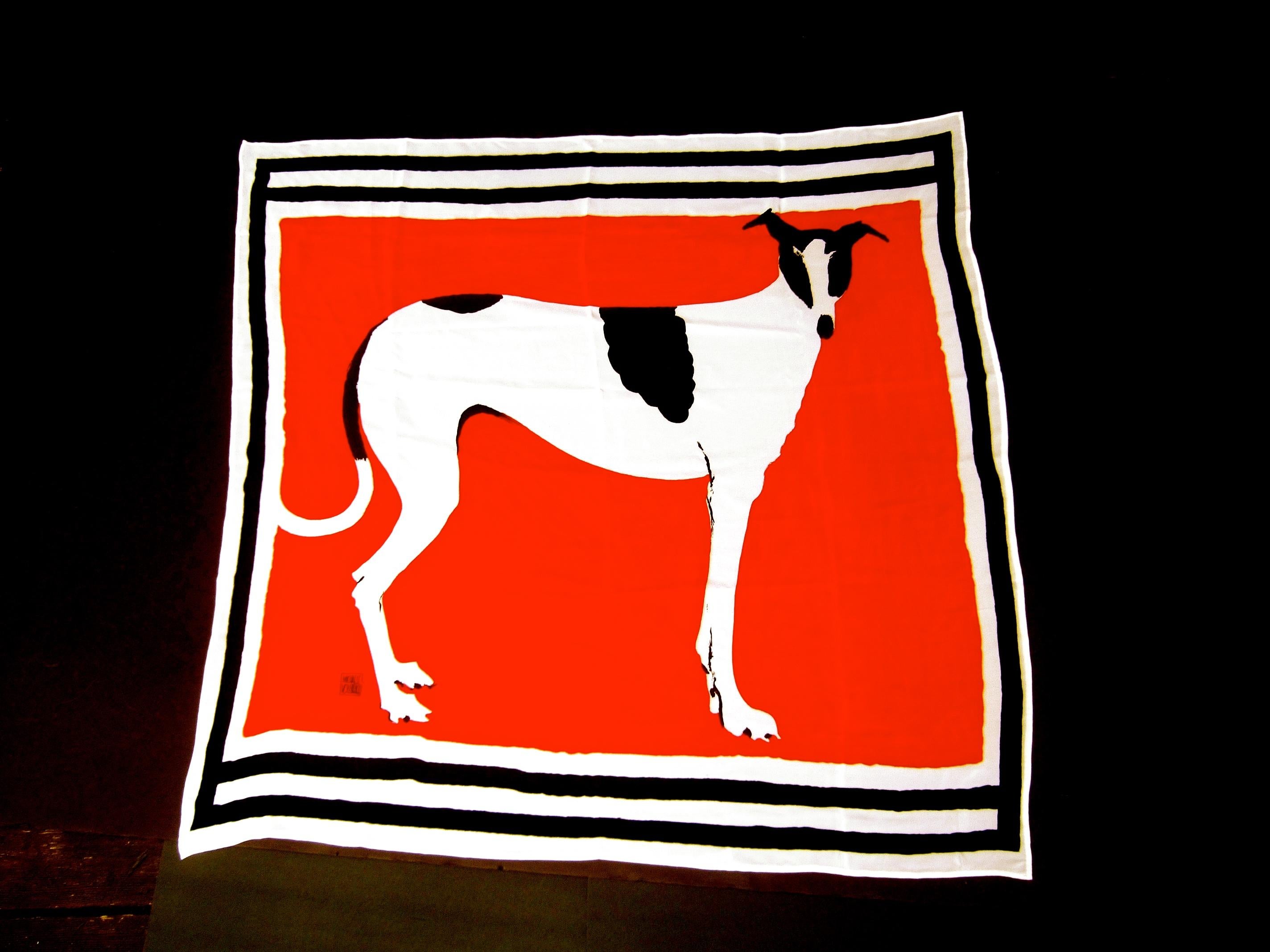 Michaele Vollbrach Spectacular large silk canine hand rolled scarf - textile c 1980s   45 x 43.5 
The bold dramatic textile is illustrated with a sleek canine figure illuminated against 
a crimson red silk background; framed with black & white