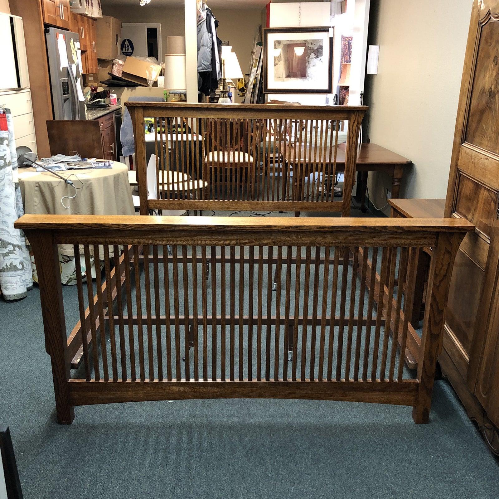 A Queen Mission bed by Michael's Furniture. Known for its quality construction, the large oak piece features dovetailed joinery, solid oak and beautiful Arts & Crafts style.

Matching five drawer dresser, mirror, pair of nightstands and 12 Drawer