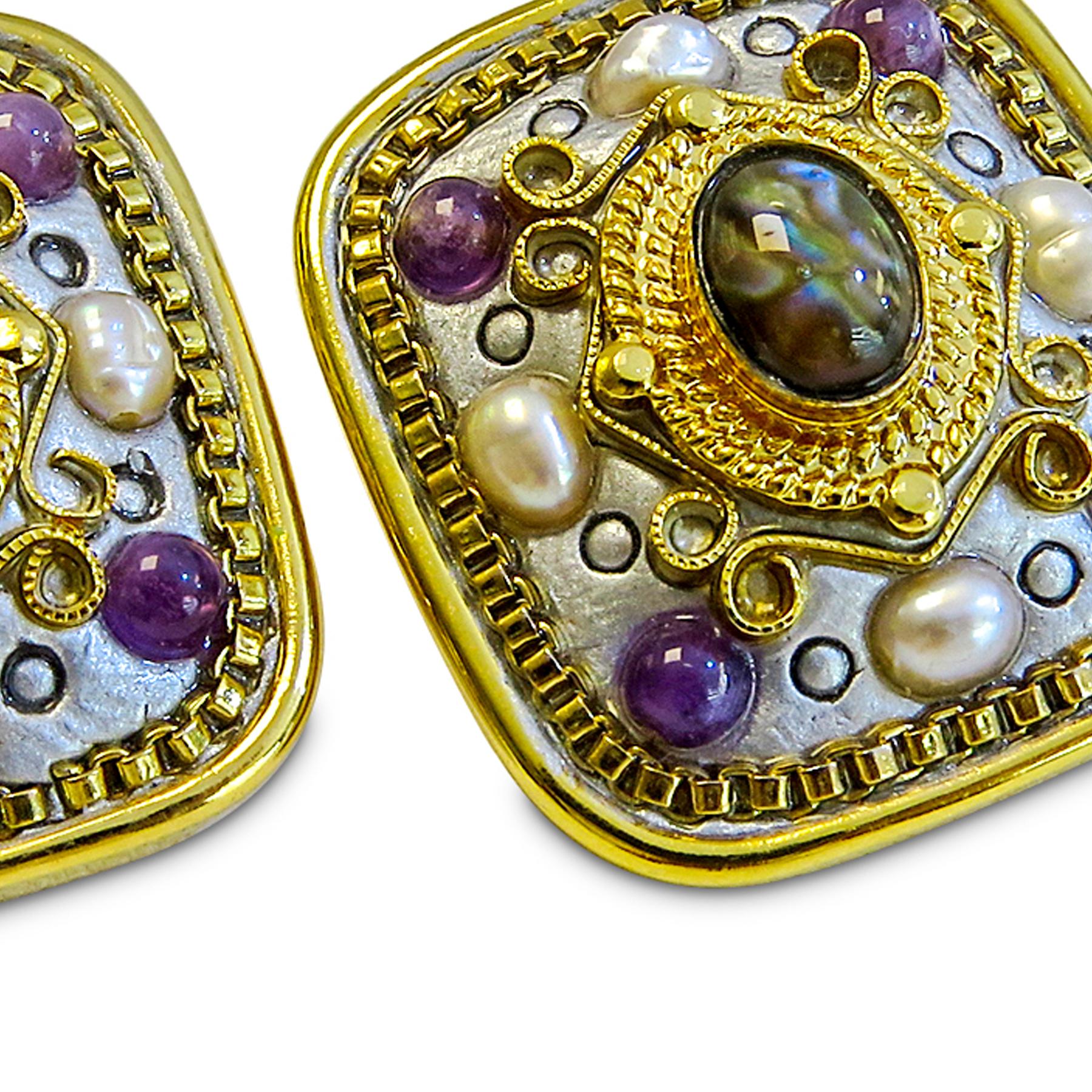 These mesmerizing Michal Golan earrings feature amethyst, pearl, and labradorite centers with an 18 Karat gold plated accent. It is 25mm by 22 mm in dimension and weighs 13.5 grams to sit flush with the ear for maximum comfort.
