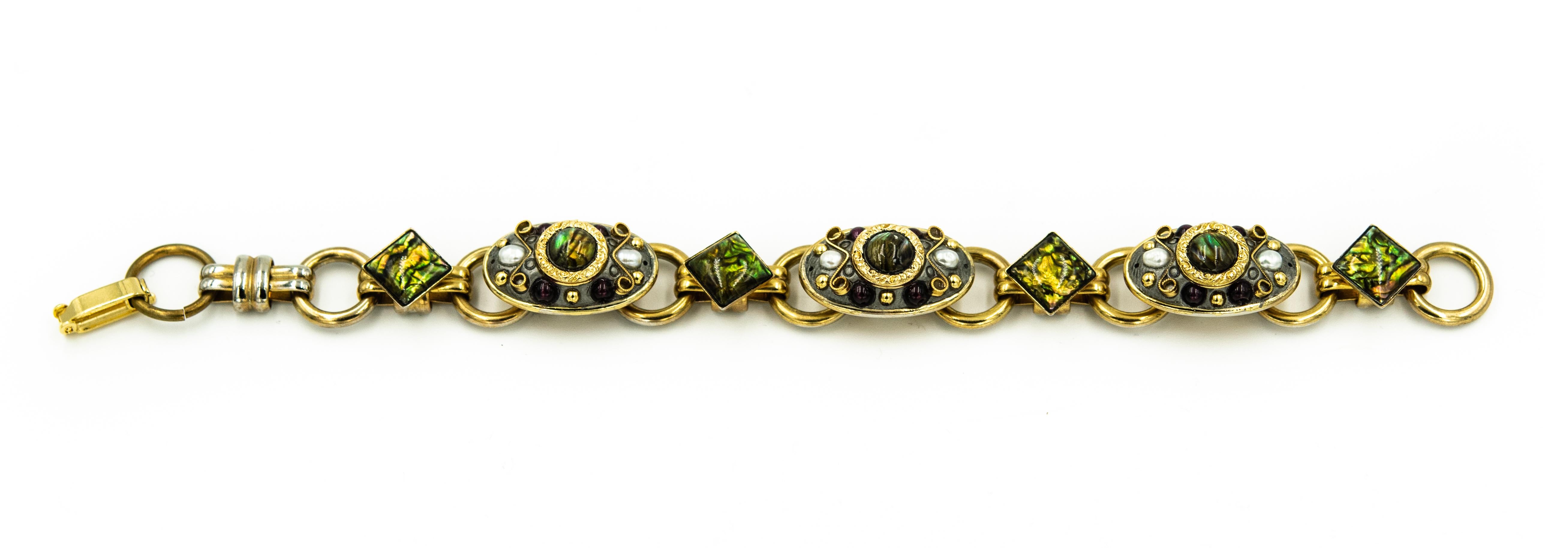 A beautiful Michal Golan bracelet and  brooch pendant set includes:   A gold plated brooch is which is adorned with seed pearls, abalone, green glass stones and beautiful filigree heart designs. Very high quality and versatile piece of jewelry art