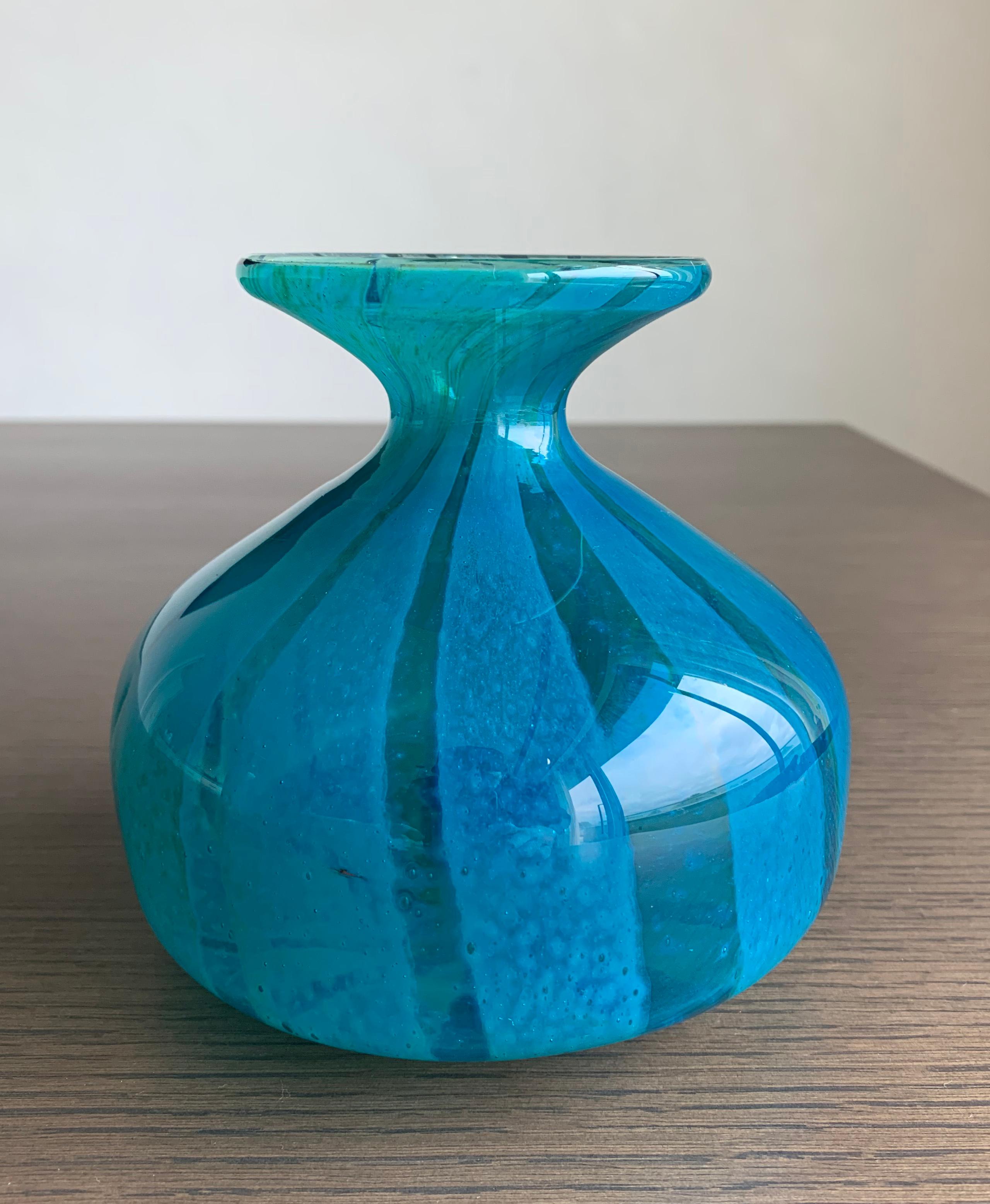 Enhance your home decor with a touch of elegance and vintage charm by adding this pair of iconic late 20th century Mdina Glass vases to your collection. 

Handcrafted by the skilled artisans of Mdina Glass, known for their exceptional glass-making