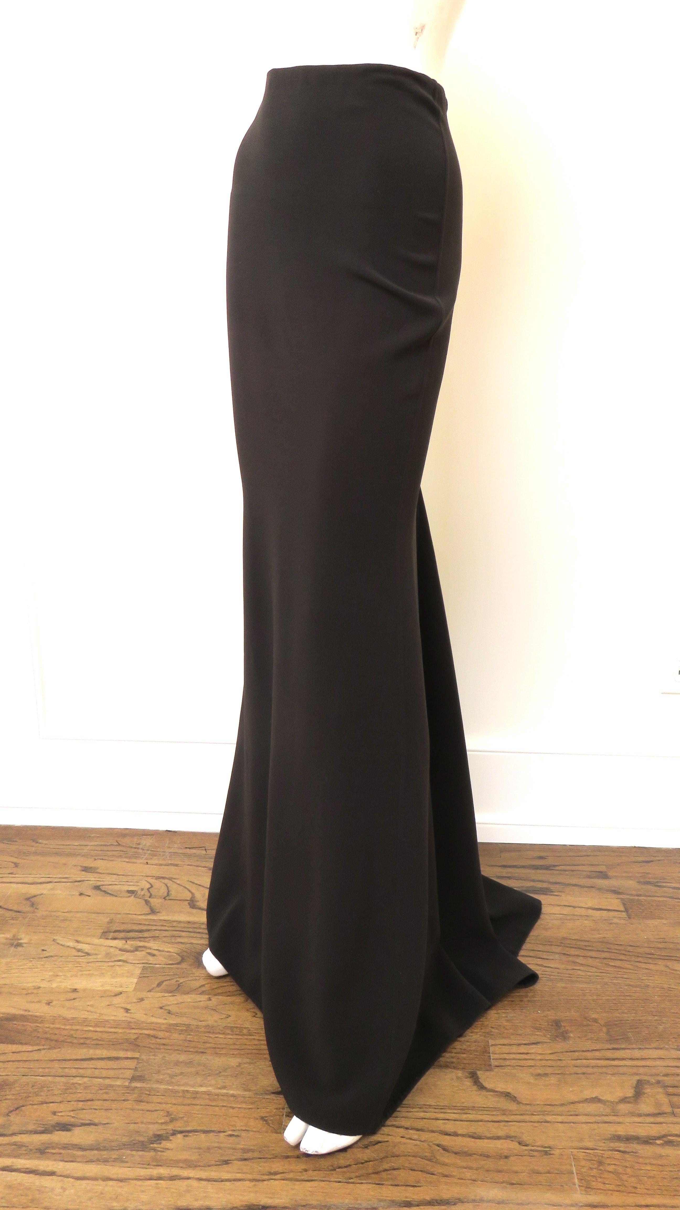 A beautiful brown wool maxi skirt from Michael Kors.  Cut on the bias for a great fit it flares at the knees with a small train in back.  It is unlined and has a back zipper. The fabric has a bit of stretch so is flexible in fit.
Fits sizes Small,