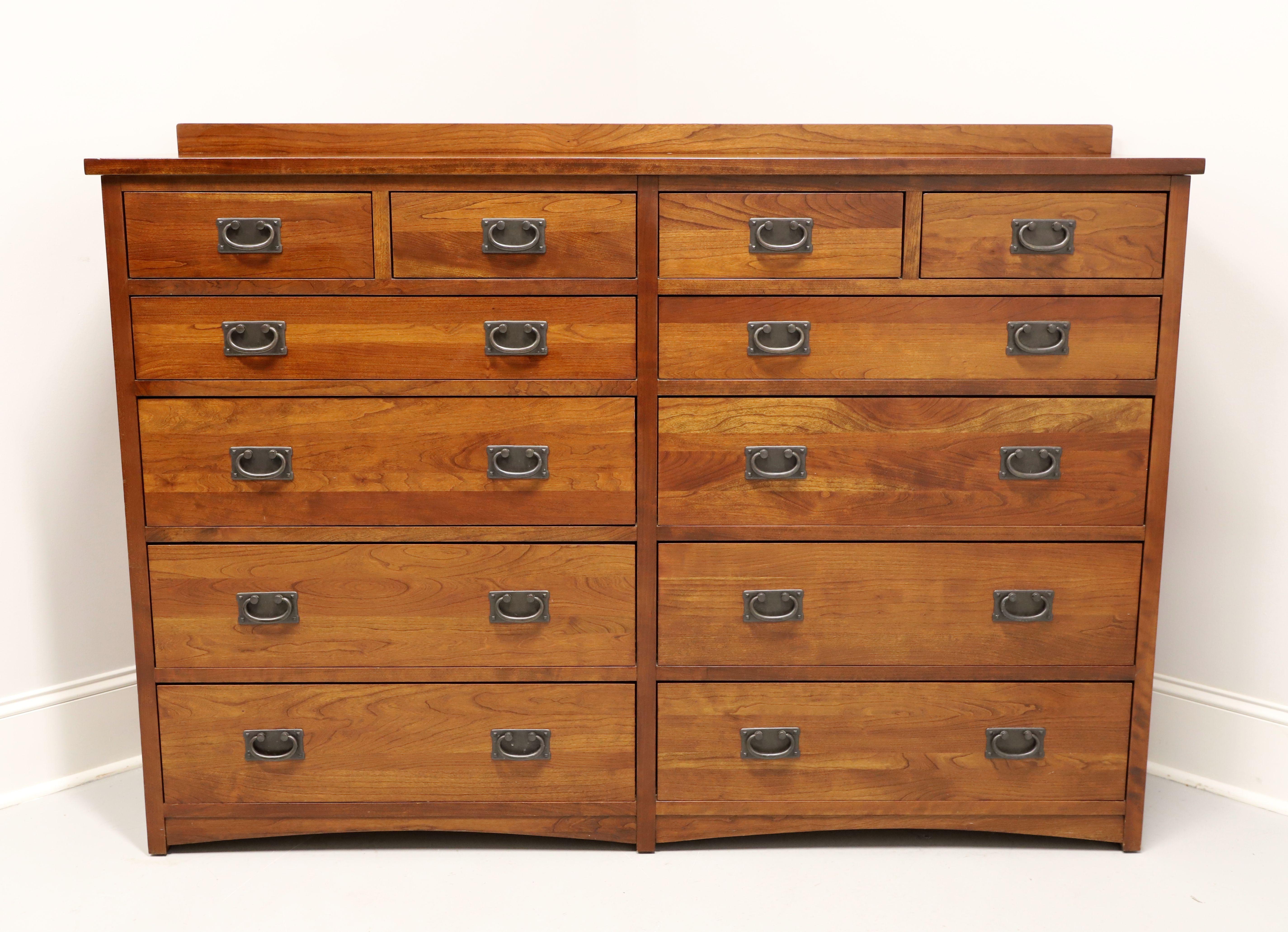 A Mission / Arts & Crafts style mule chest of drawers by Miller Bedrooms, fine Amish made furniture, from their Micheal's Mission Collection. Solid cherry with cedar drawer interiors, brass hardware, square edge top with a back gallery, carved