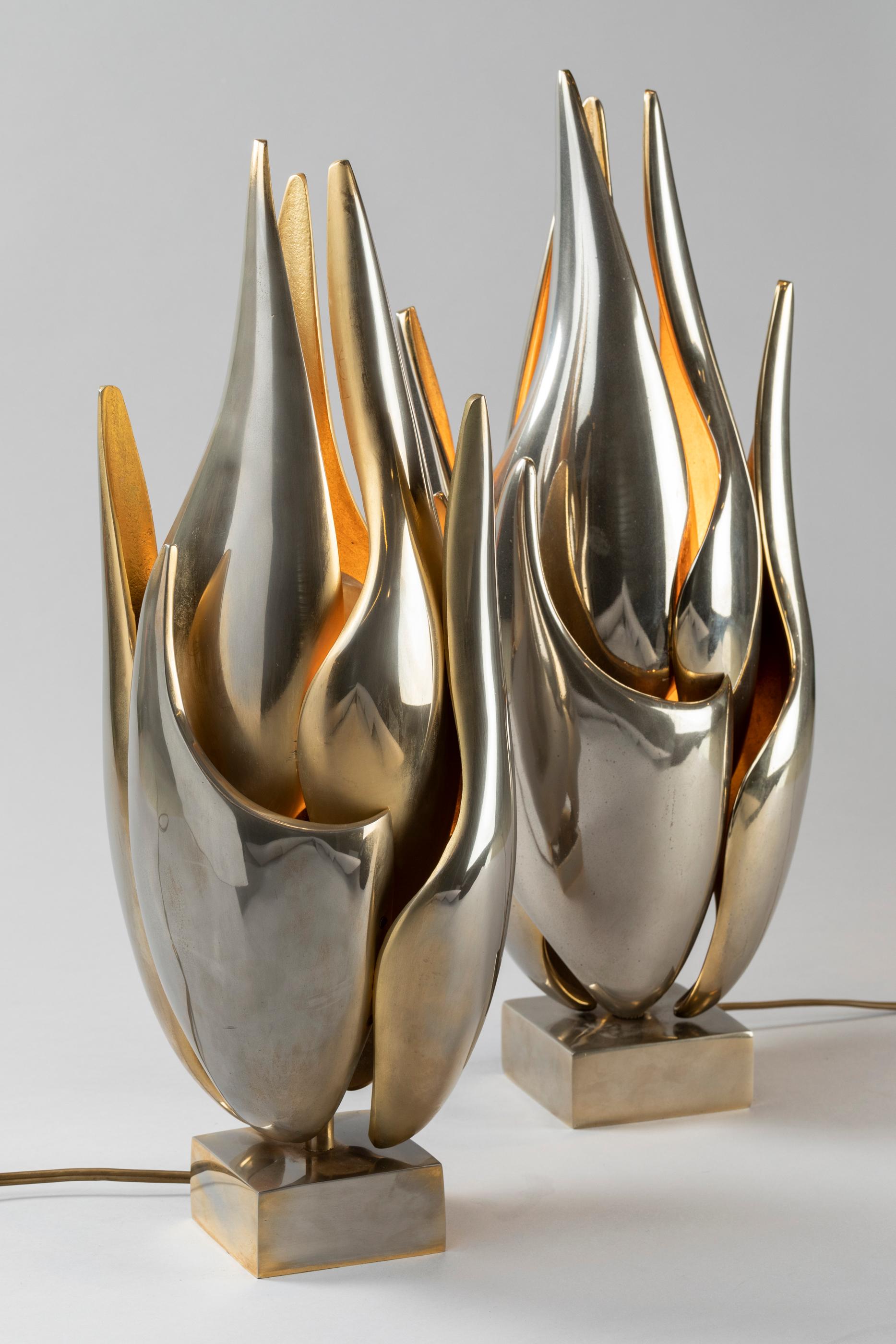 A pair of graceful sculptures lamps in Zamak: a special alloy of Zinc, aluminium and copper which gives an unusual mat patina.
These light sculptures with gold finished have been made in 1978 by Michel Armand.
  