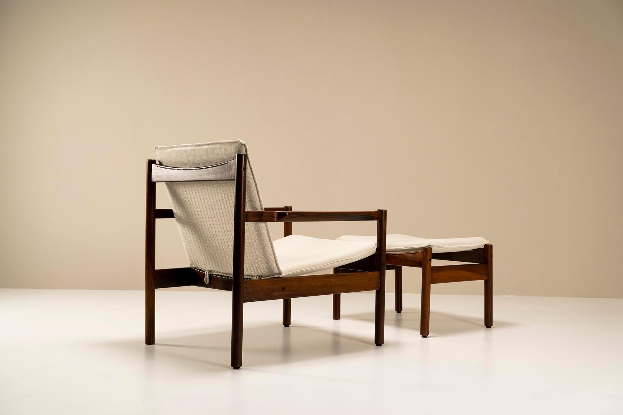 Michel Arnoult “Ouro Preto” lounge chair in imbuia wood with ottoman from 1958. Michel Arnoult left his native France for Brazil in the 1950s and quickly befriended the famous architect Oscar Niemeyer and painter Cândido Portinari. He then set up