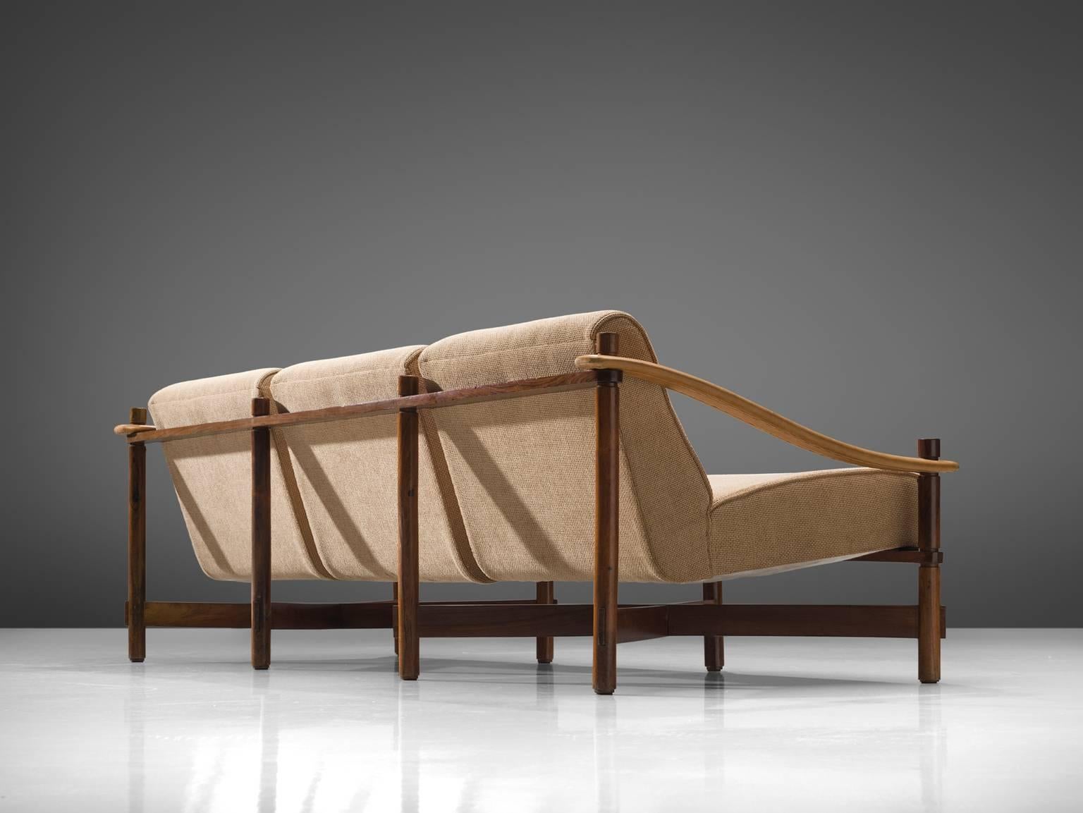 Michel Arnoult for Mobilia Contemporanea, three seater sofa, rosewood, leather, beige fabric, Brazil, 1965.

This rare Brazilian sofa is of the highest-quality in both material and design. The combination of the thick woolen upholstery, the warm