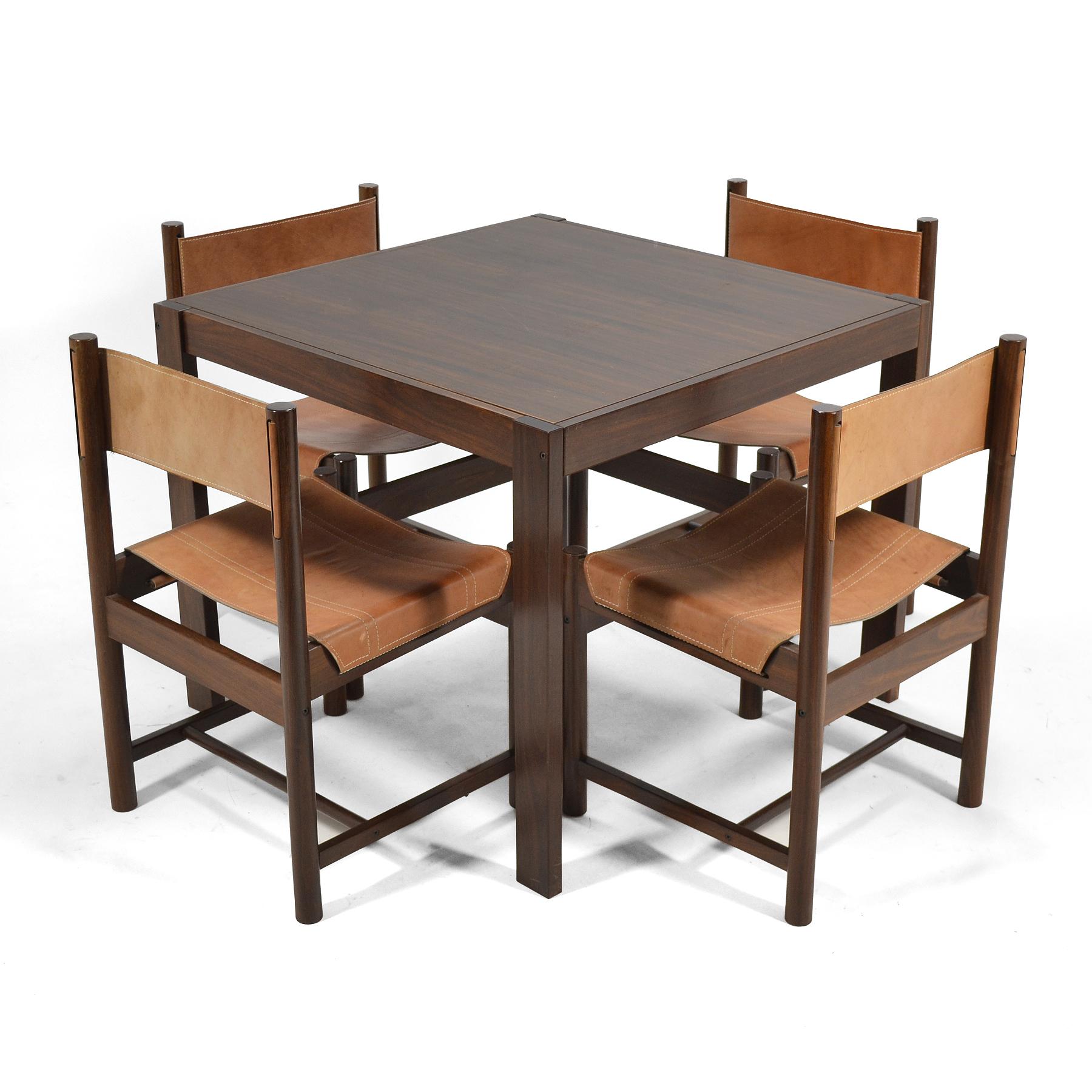 This striking table and chairs were designed by Michel Arnoult as part of his Alagoas collection for Forene S.A. Moveis do Nordstrom in Brazil. Crafted of solid exotic hardwood (possibly rosewood) the architectural chairs have seats and backs are