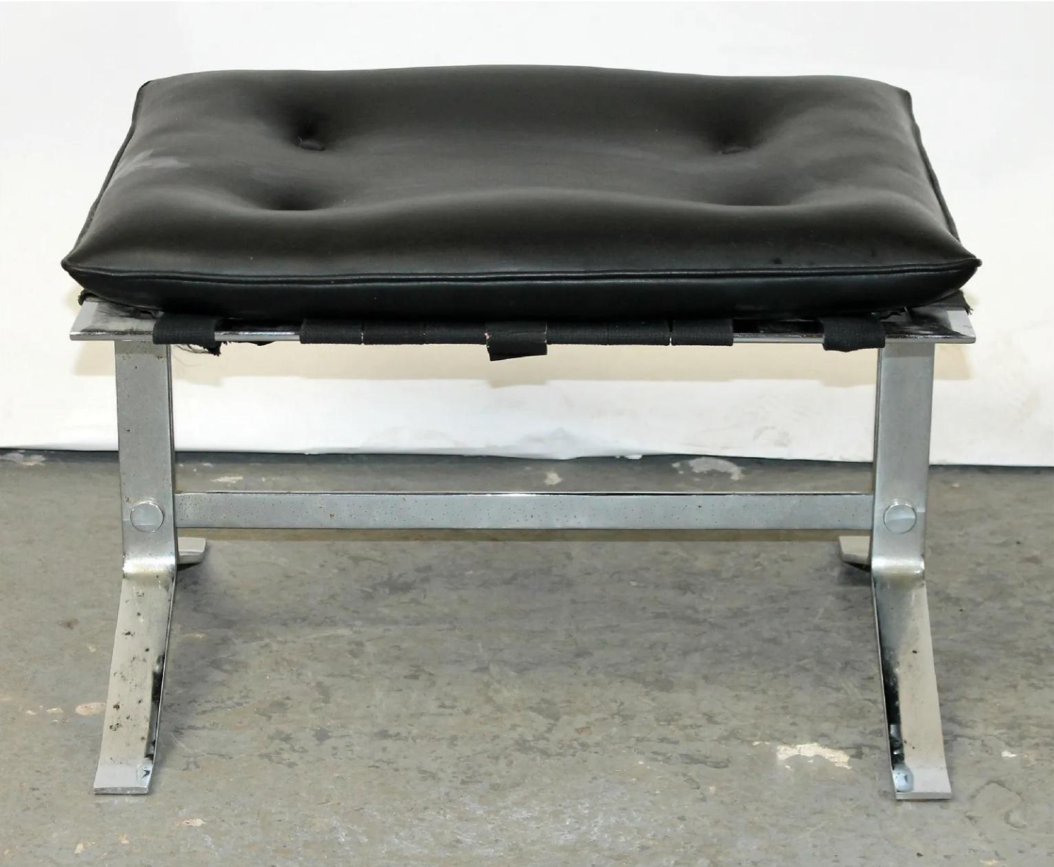 20th century French stainless steel and black leather footstool in the style of Michel Boyer. The tufted leather top can be removed from the steel frame. 