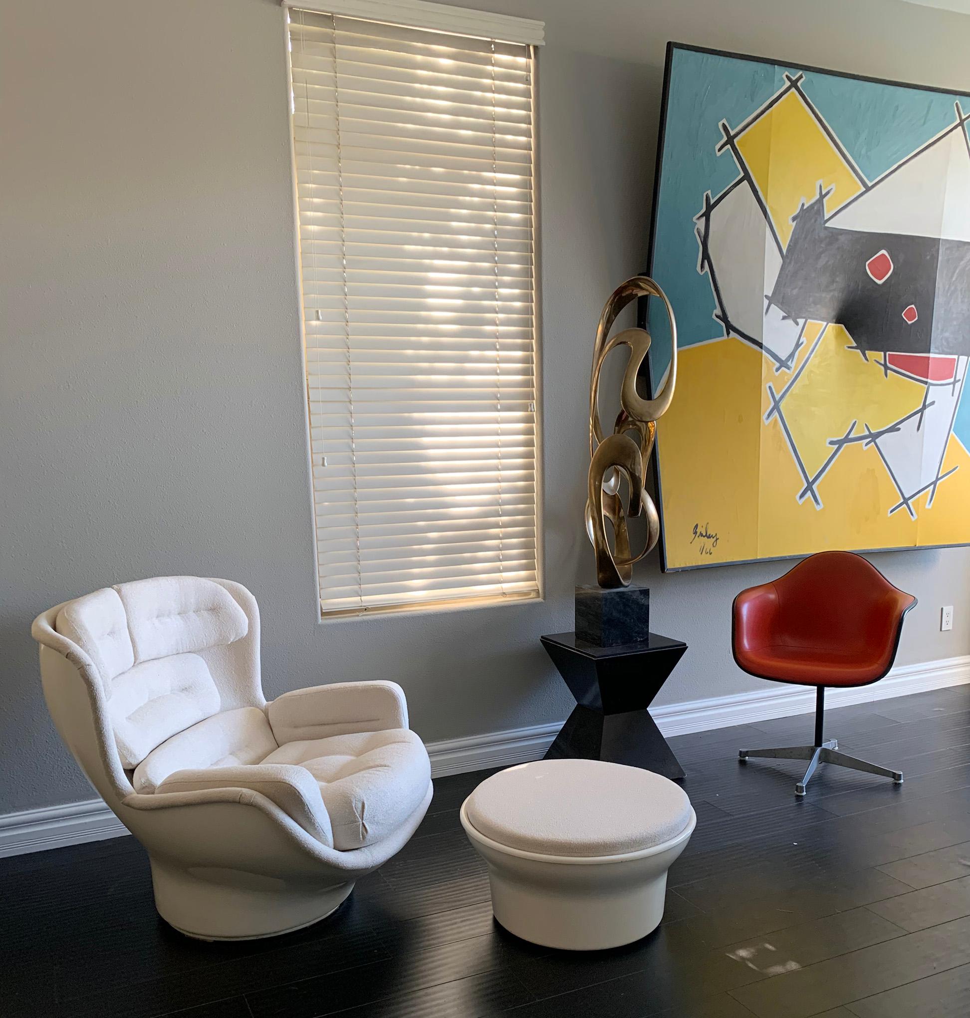 This one of a kind chair is the brainchild of our gallery. After picking up a 1970s space age fiberglass chair designed by Michel Cadestin Karate chair, we couldn't help but notice how sloppy the vintage vinyl button tufted upholstery was. We then