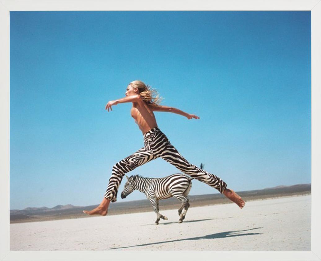 Die Schöne und das Biest II - Tatjana springt mit Zebra, Fine Art Photography, 1996 (Blau), Color Photograph, von Michel Comte