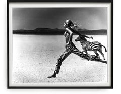 Beauty and the Beast - nude model running through the desert with a zebra b&w