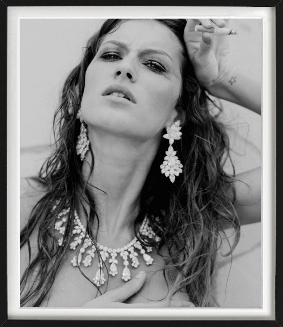 Black-and-white Portrait of Topmodel Gisele Bündchen with luxurious jewelry and cigarette, photographed by Michel Comte in Cannes for Vogue Italia 1999.

All prints are limited edition. Available in multiple sizes. High-end framing on request.

All