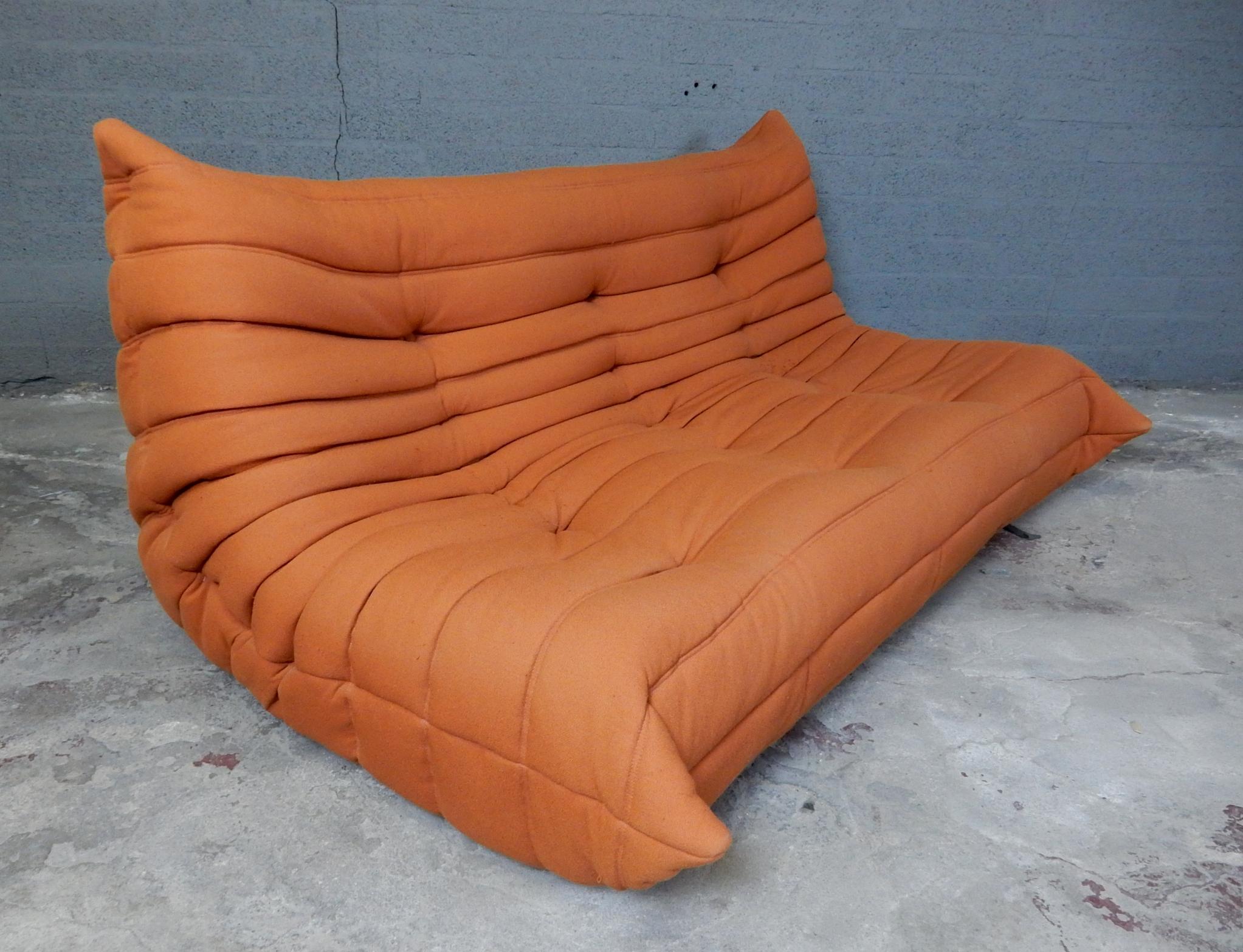 1980s Ligne Roset Togo sofa set in its original rare soft orange fabric.
Set consists of one three-seat, one two-seat, one corner seat and one floating ottoman.
Ultra comfortable!