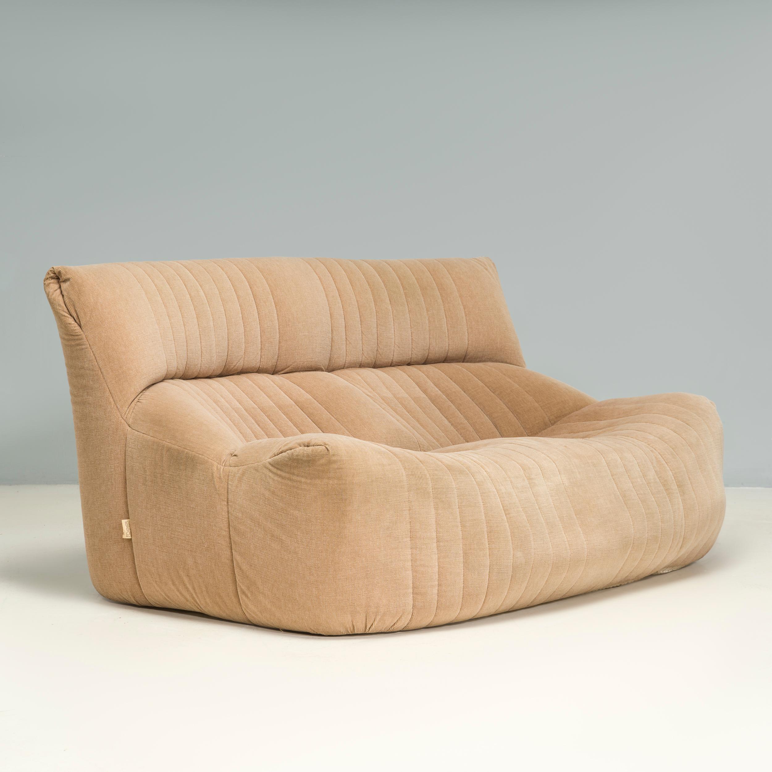 Designed by Michel Ducaroy for Ligne Roset, the Aralia sofa is similar in style to the iconic Togo and Kashima designs.

Built for laid back comfort, the two seat sofa is constructed solely from foam with a boxy silhouette and angled